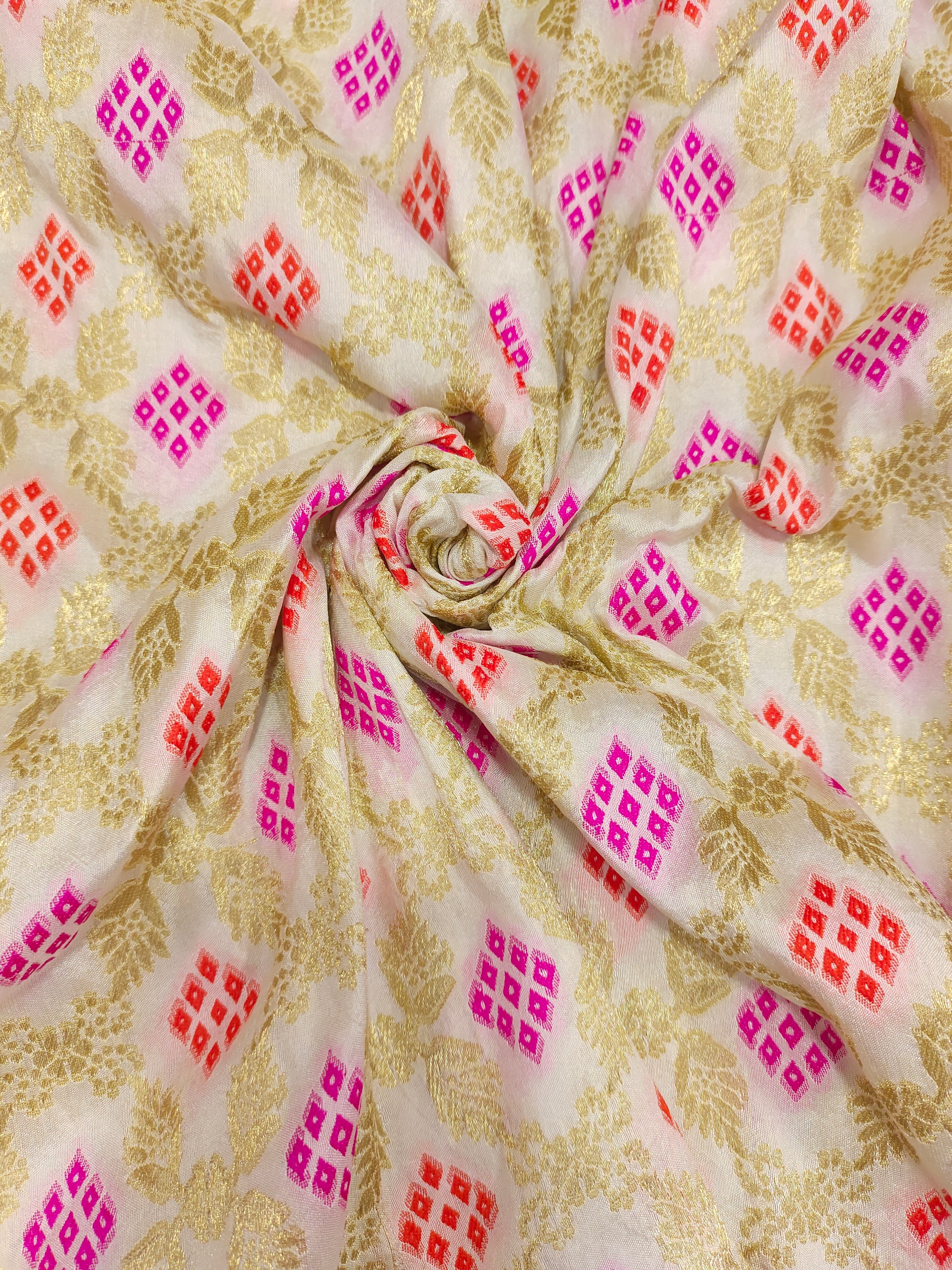 Banarasi silk fabric weave of pink and orange outline gold