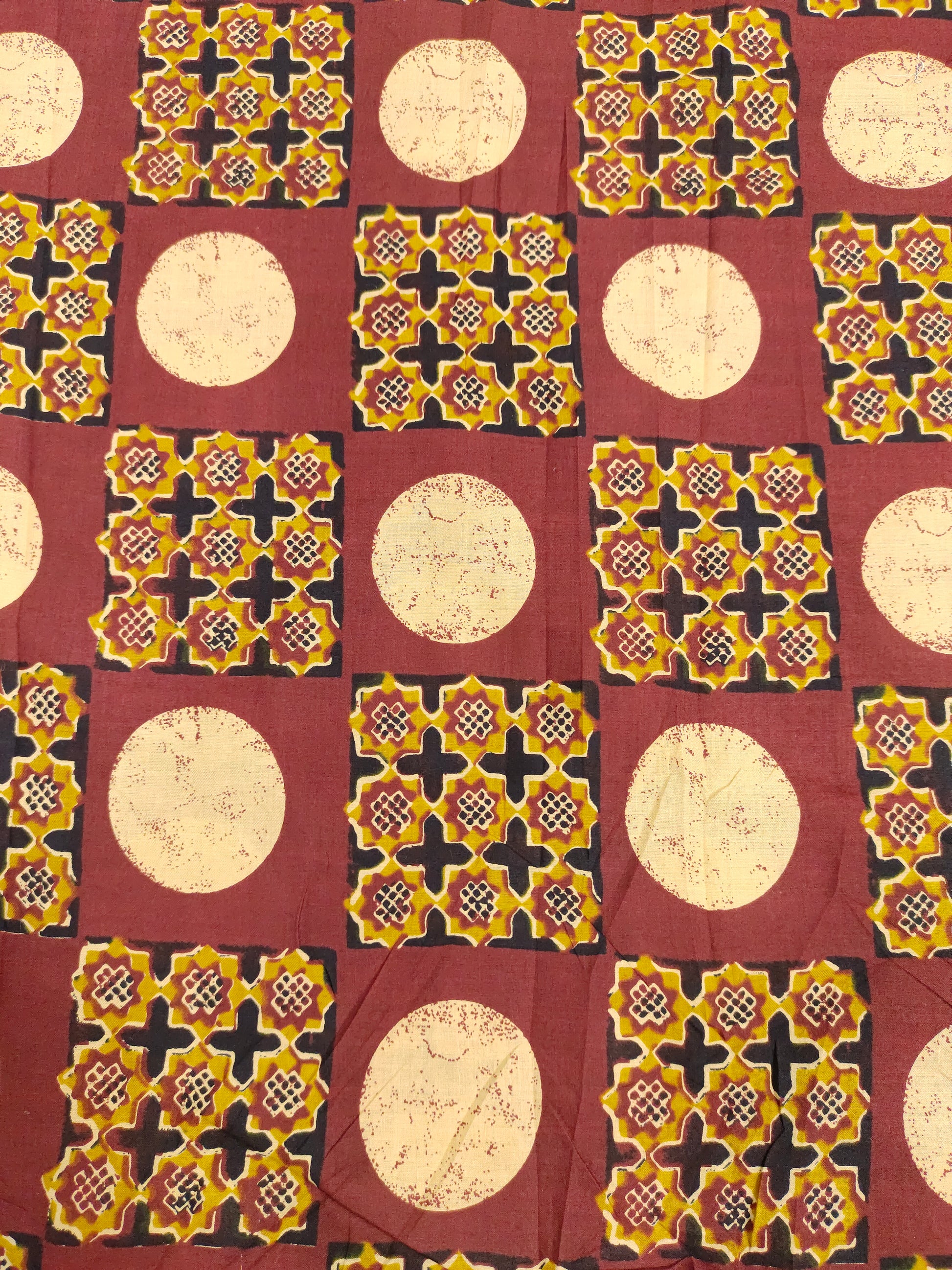 Cotton screen print maroon fabric with yellow white and black