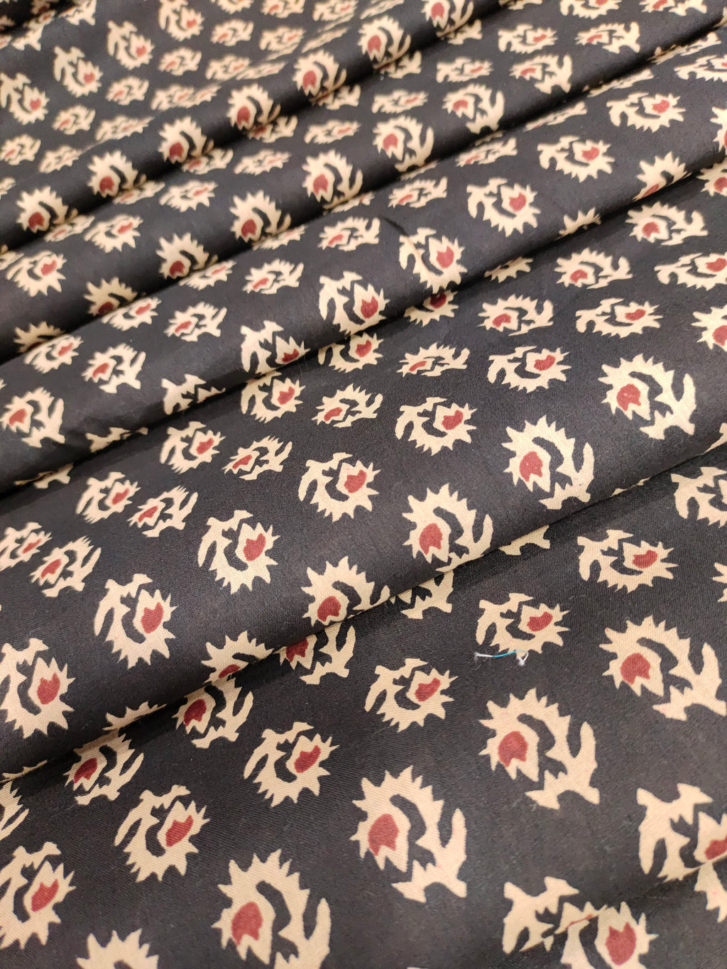 cotton fabric black with beige & rust motifs