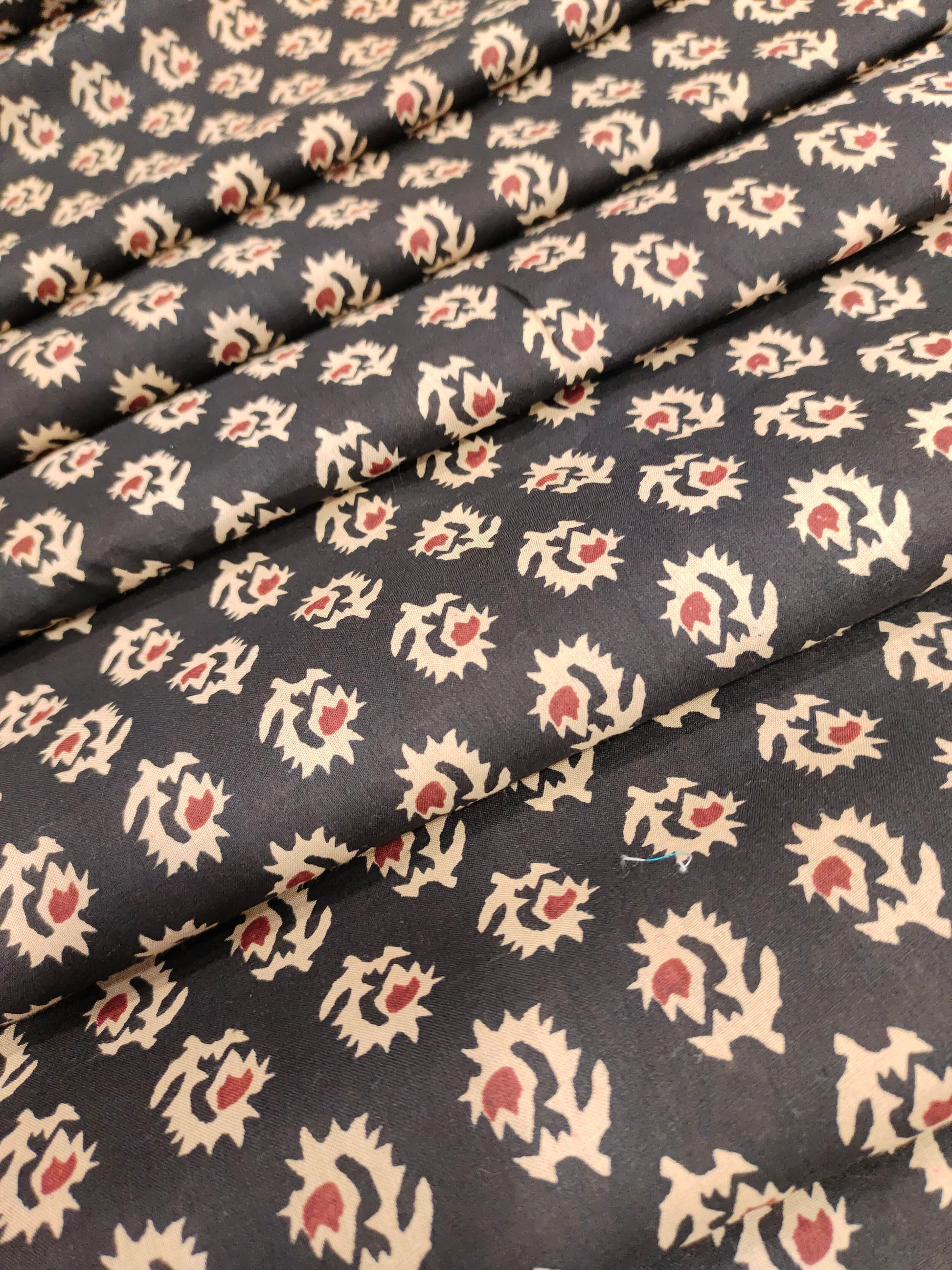 cotton fabric black with beige & rust motifs