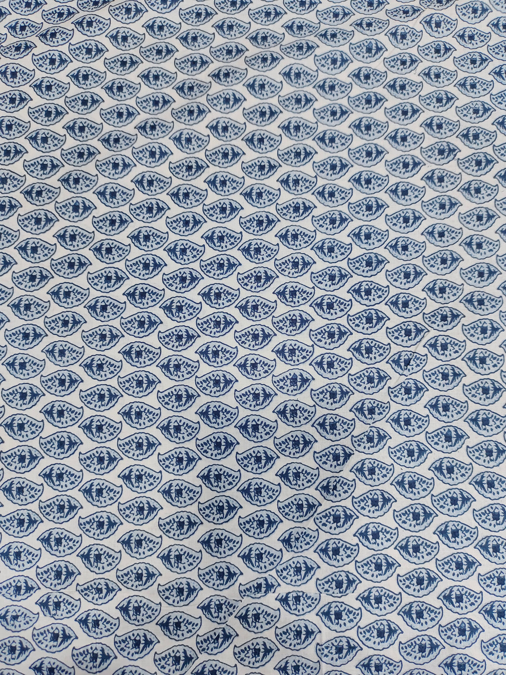 White color fabric with blue leaves print