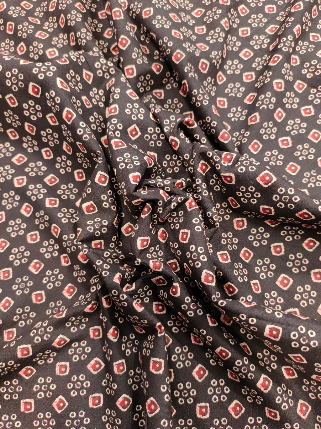 Black fabric with maroon and beige print