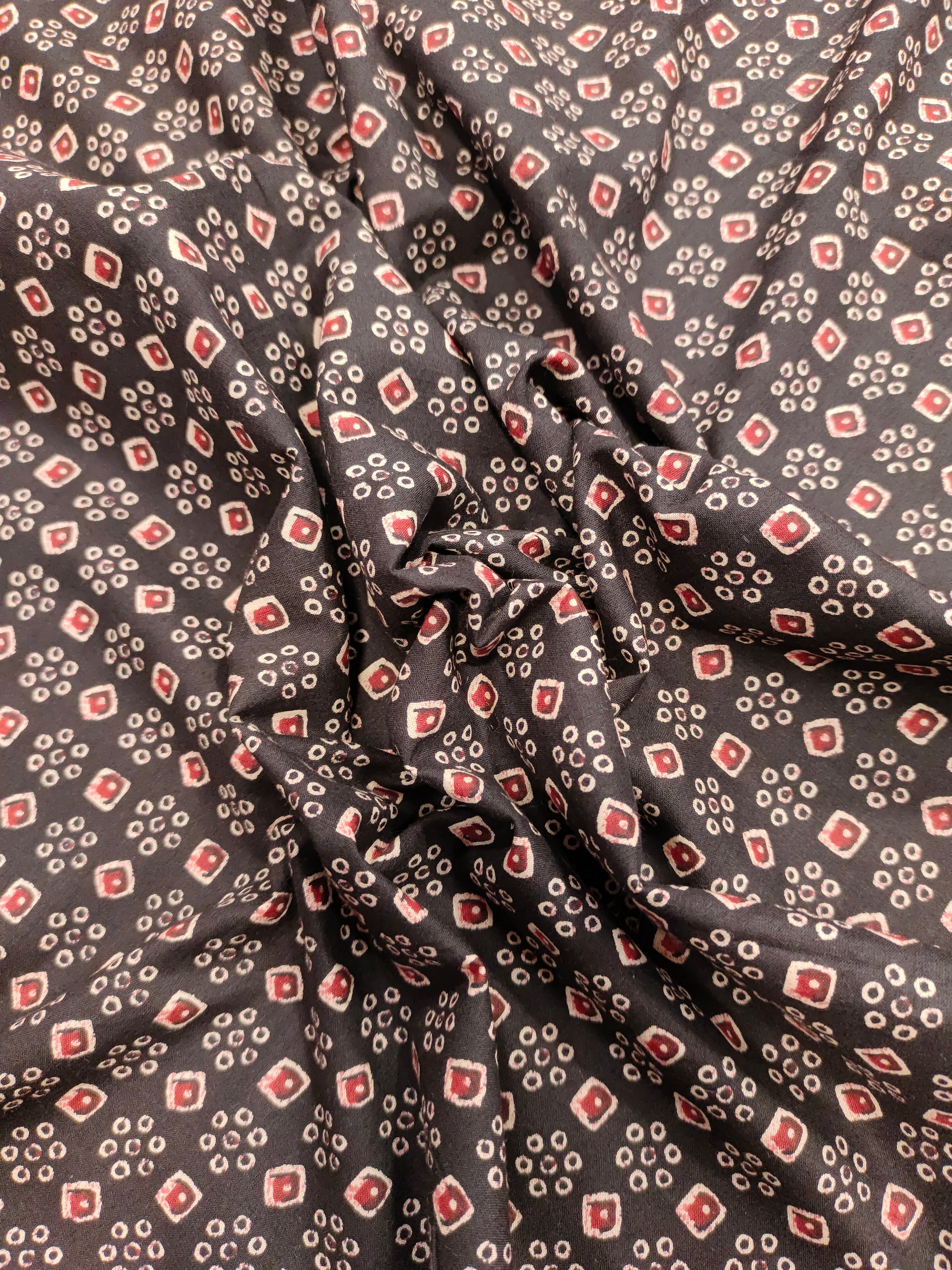 Black fabric with maroon and beige print