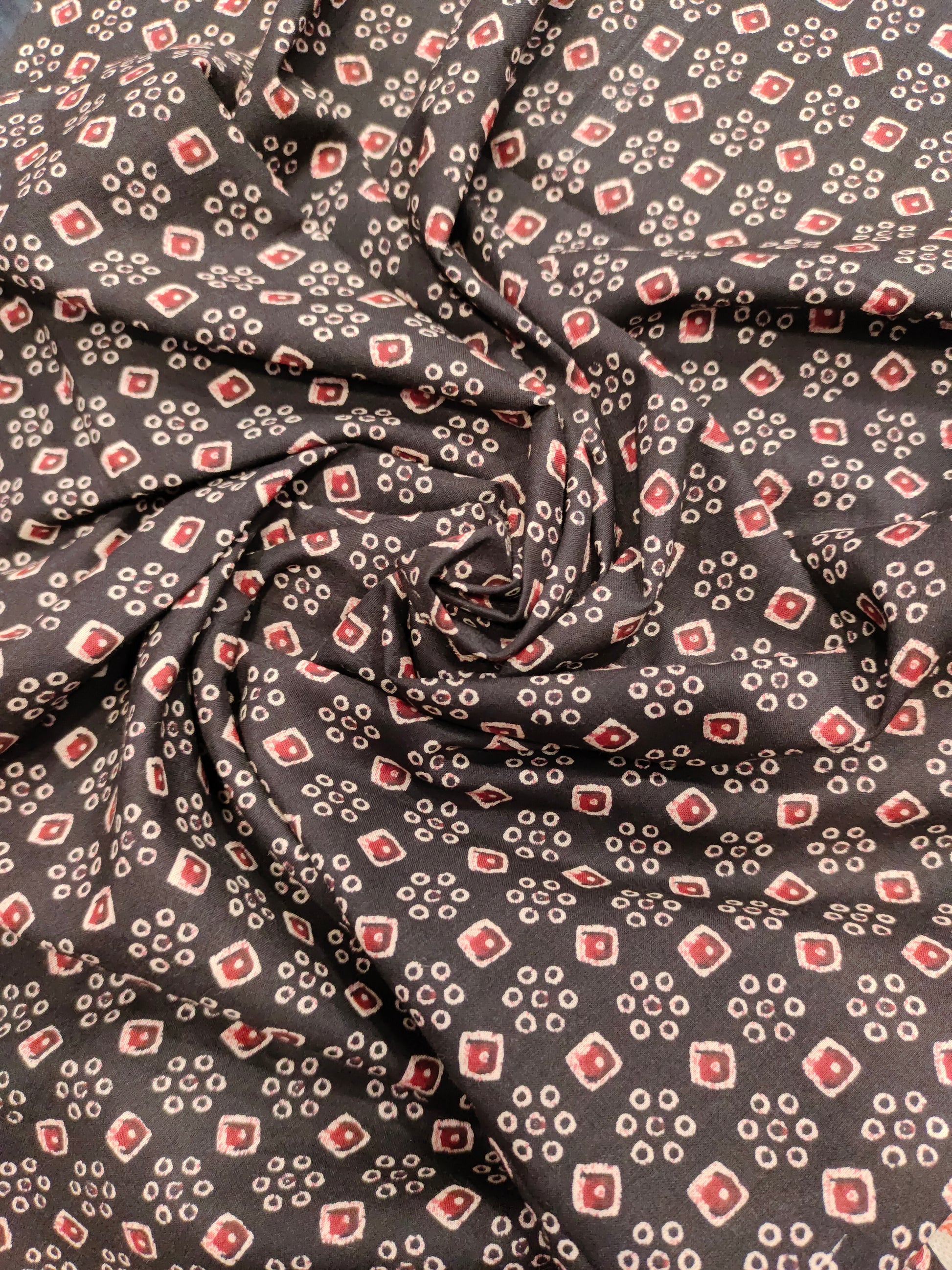 Black fabric with maroon and beige print