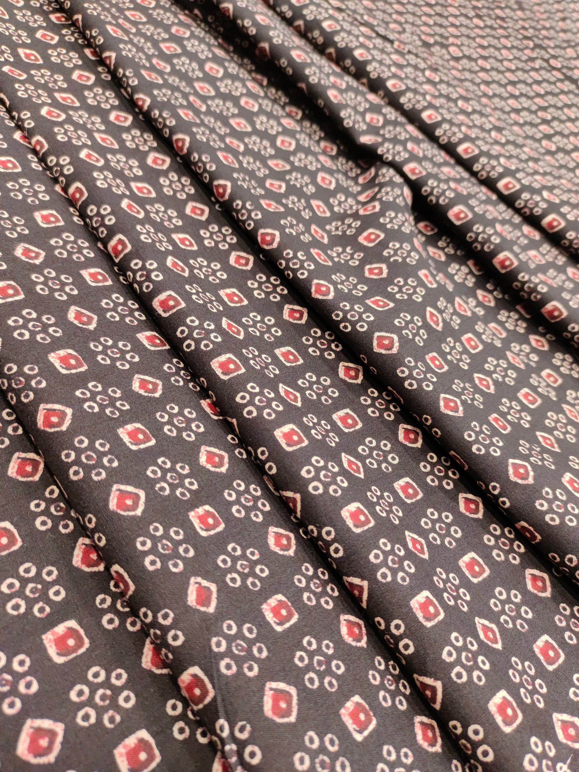 Black fabric with maroon and beige print