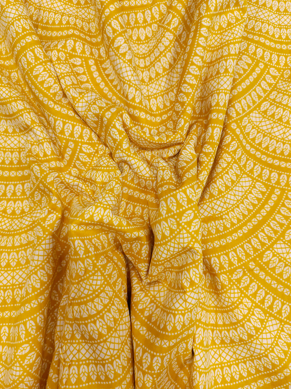 Yellow cotton half circular print.