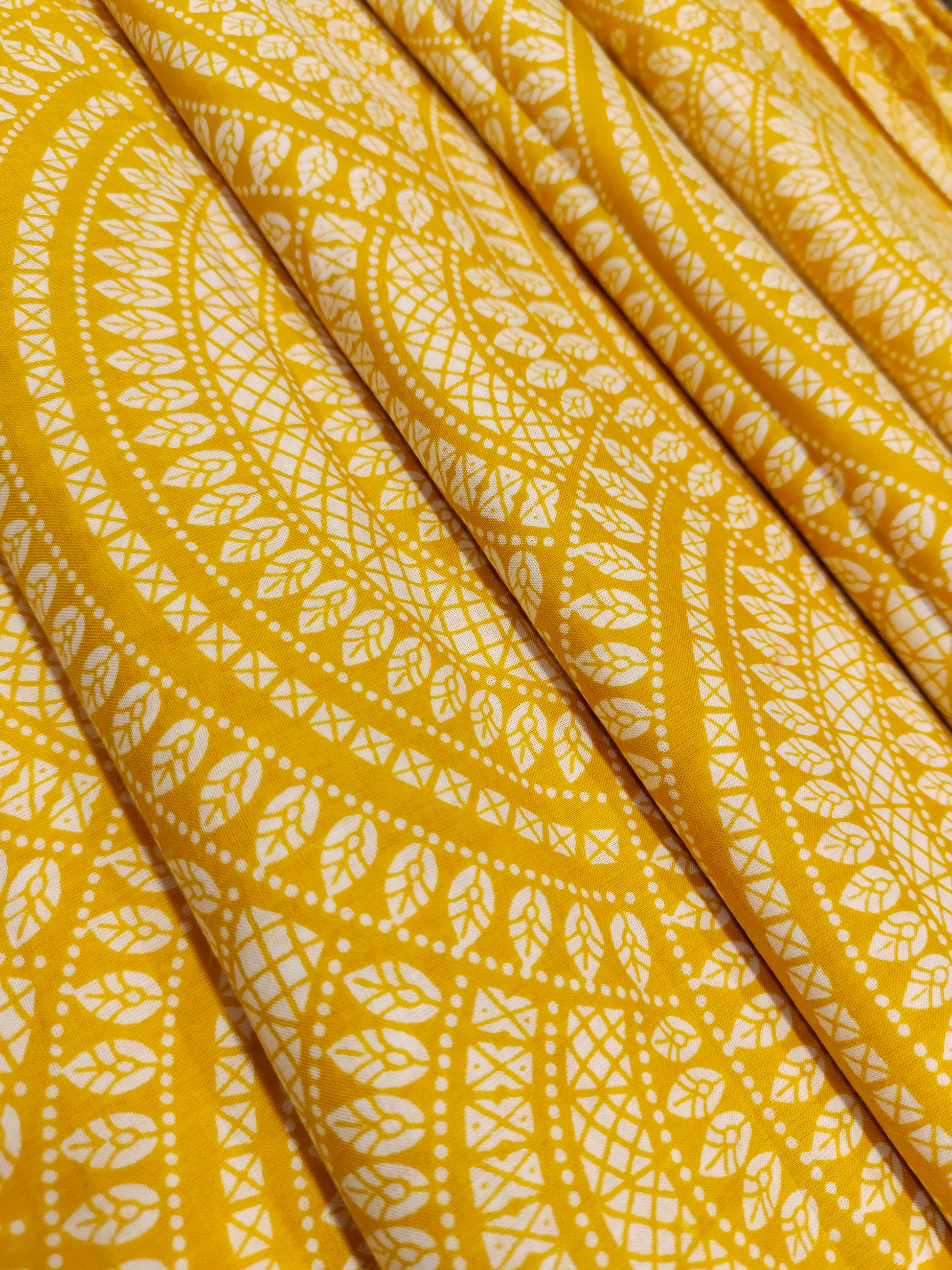 Yellow cotton half circular print.
