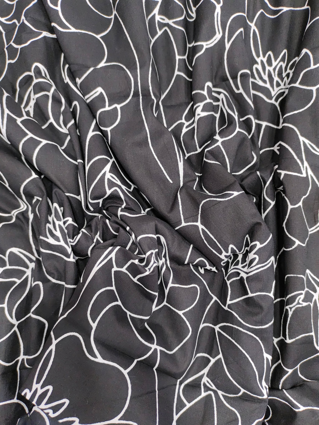 Black screen print with big flowers.