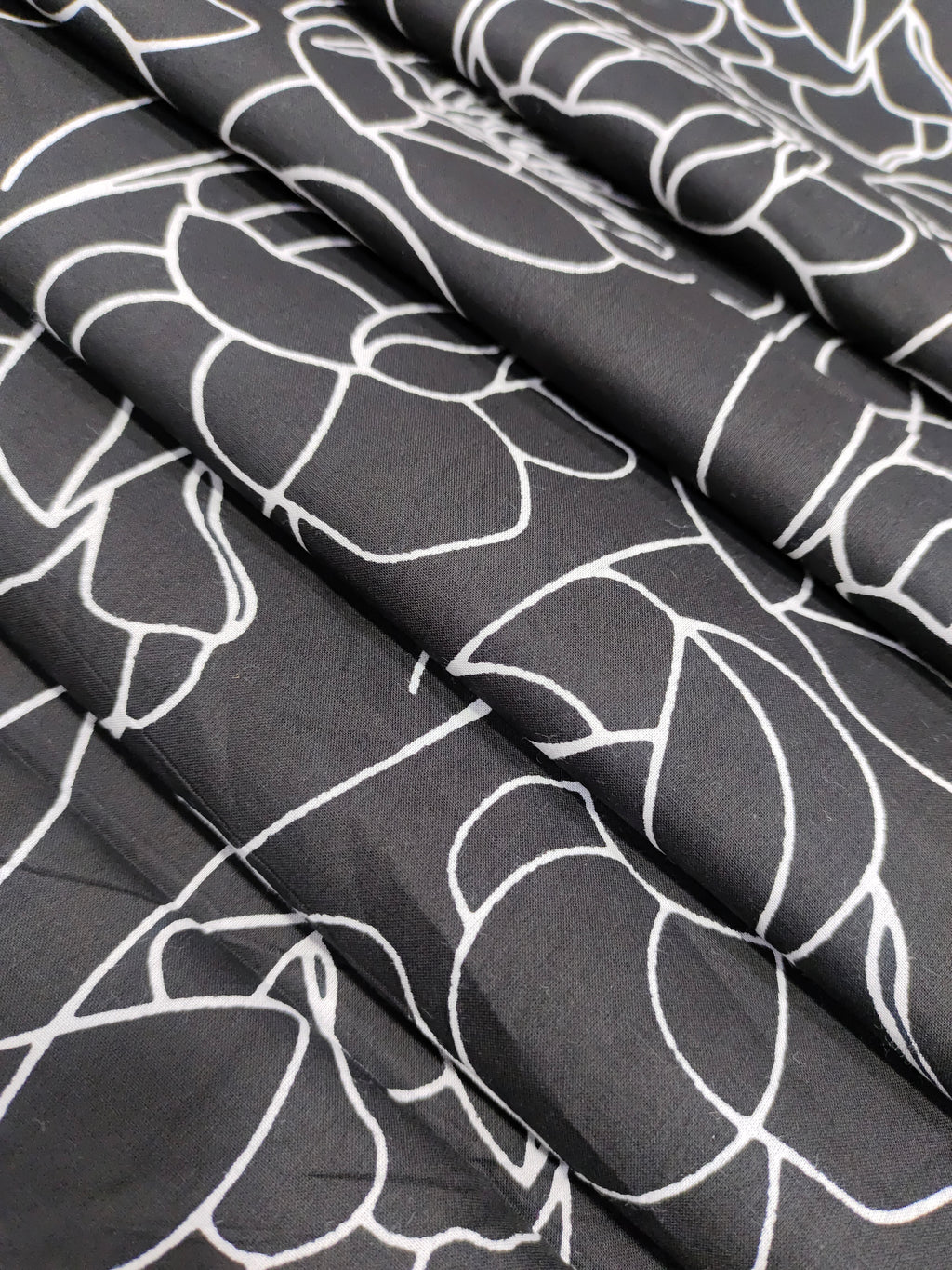 Black screen print with big flowers.