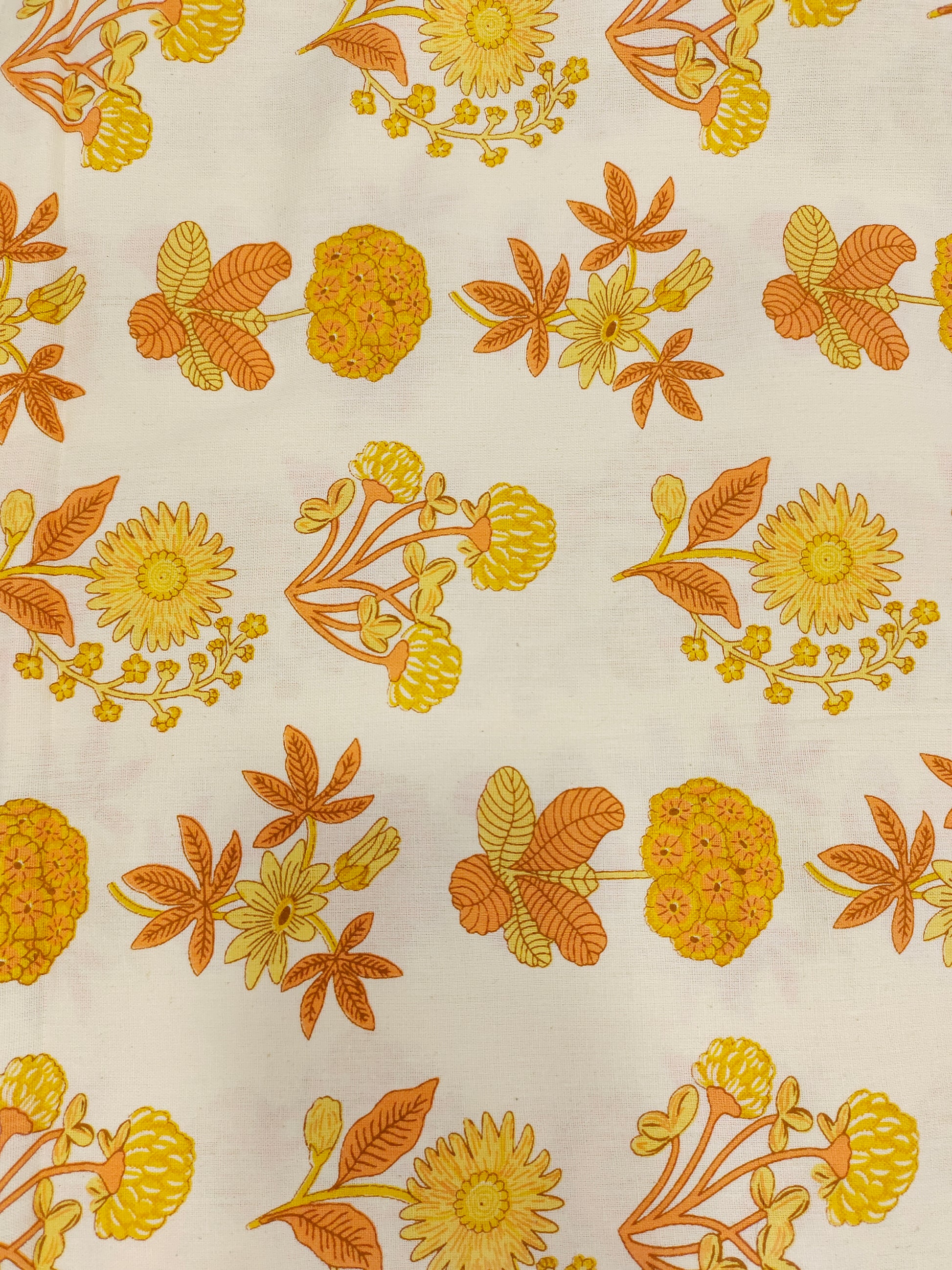 Cotton flex printed with orange and yellow floral print.
