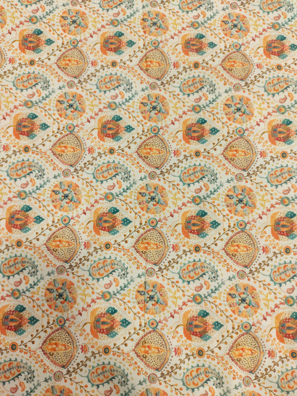 Cotton digital print with orange and blue on cream base.
