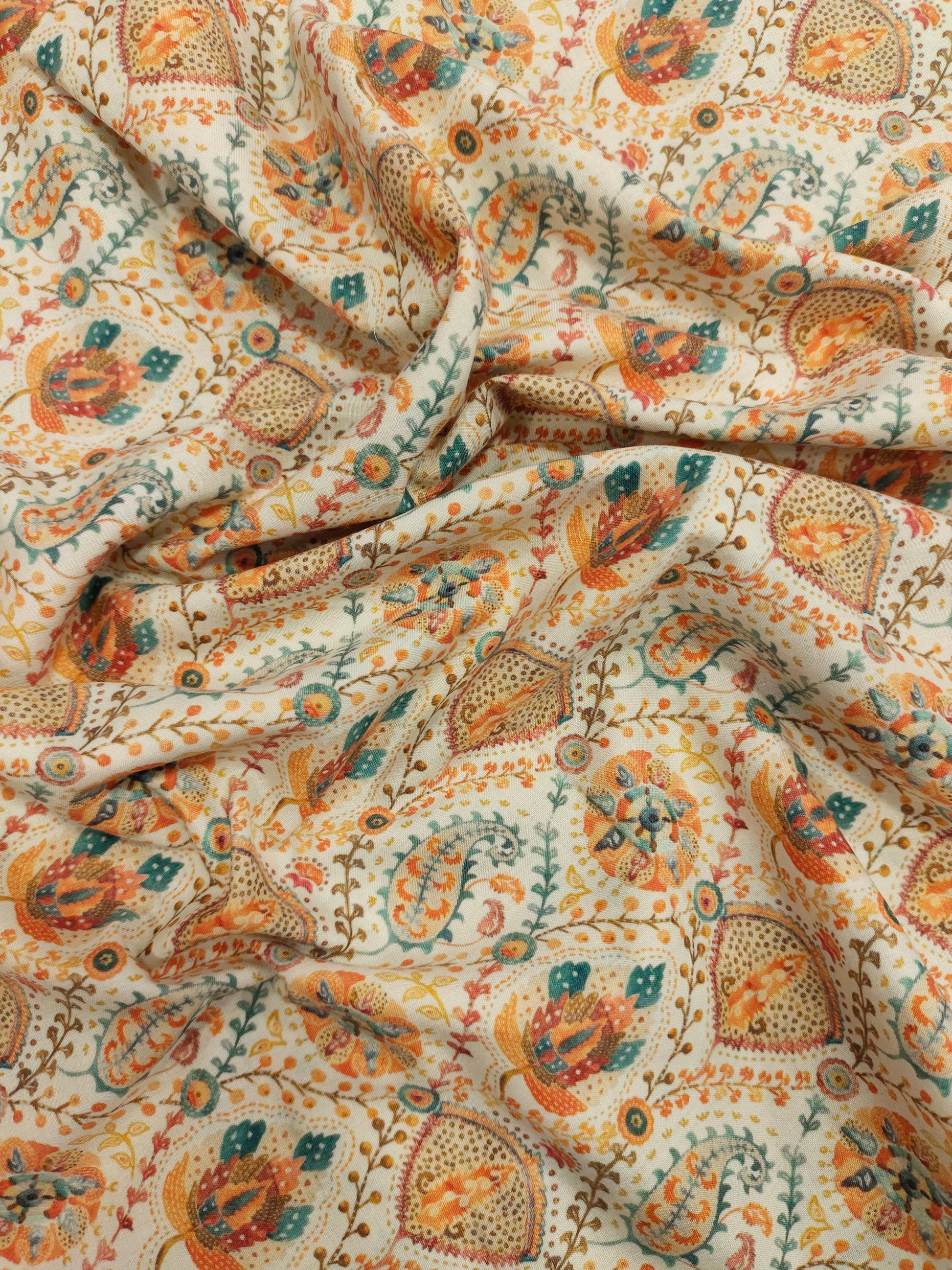 Cotton digital print with orange and blue on cream base.
