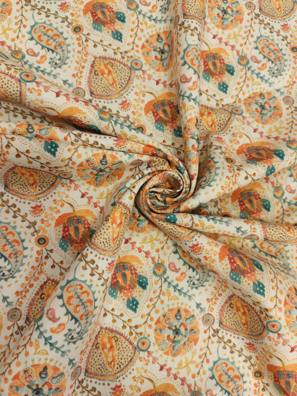 Cotton digital print with orange and blue on cream base.
