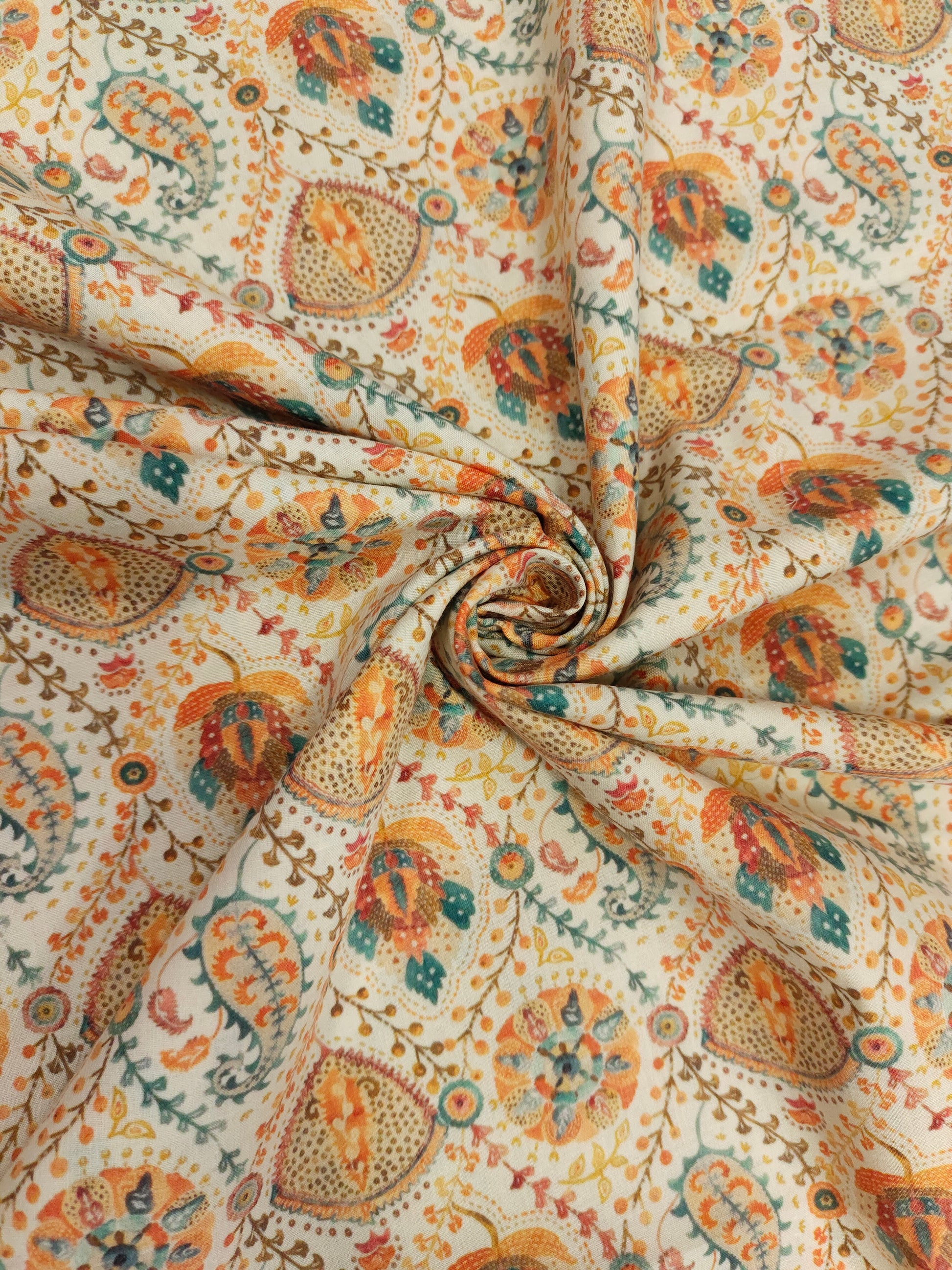 Cotton digital print with orange and blue on cream base.