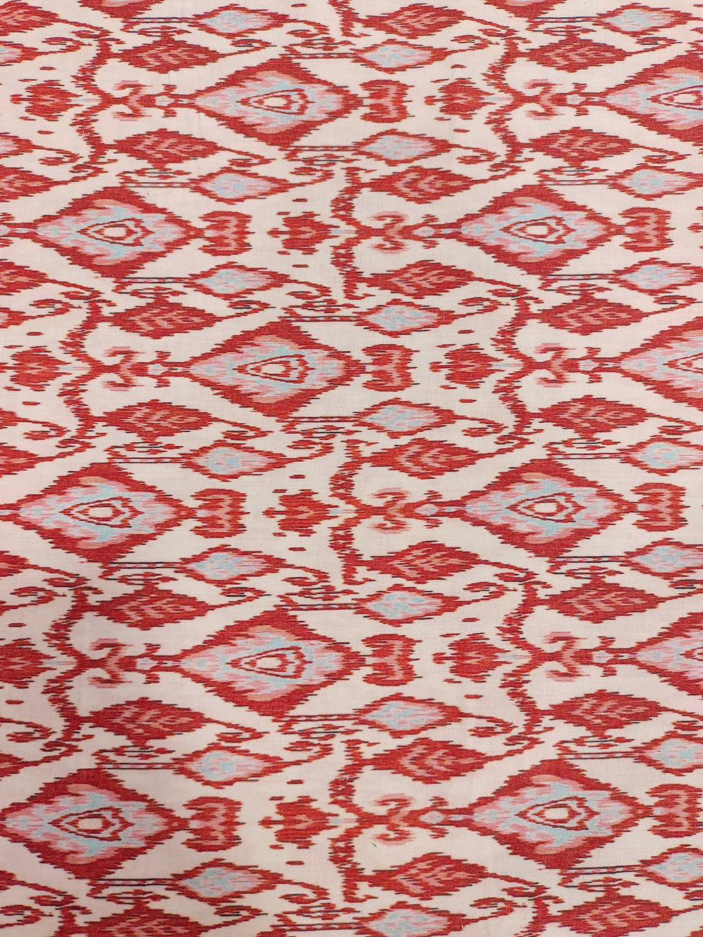Cotton cream base with ikkat type red and grey print.