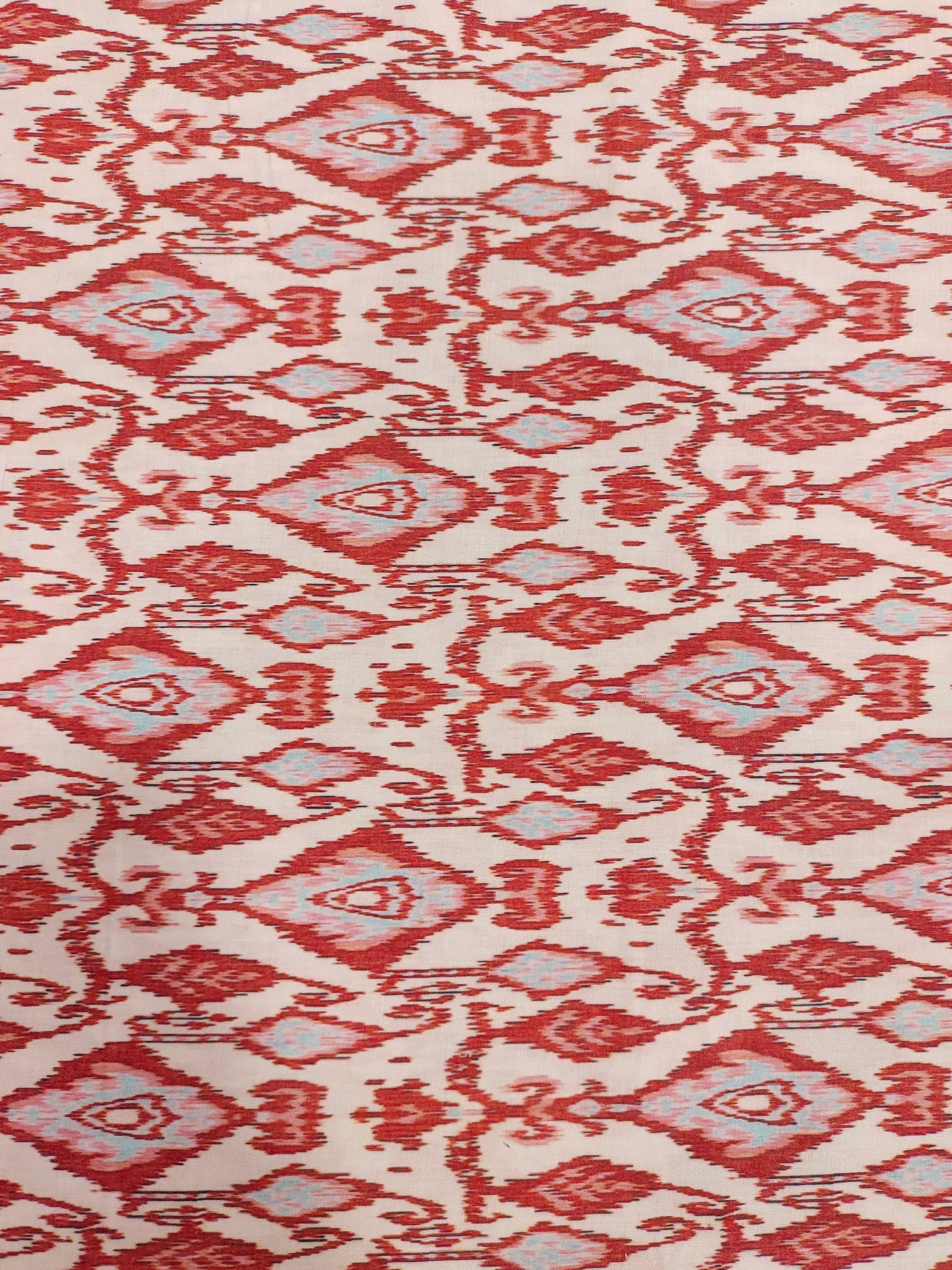 Cotton cream base with ikkat type red and grey print.