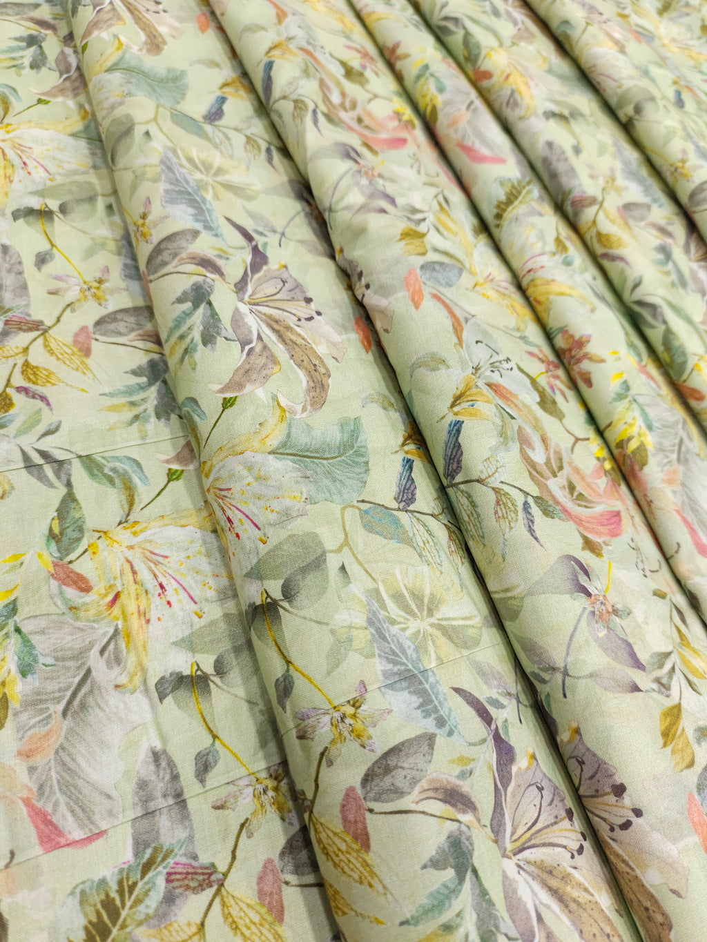 Light pista green pure cotton digital print fabric with yellow green and peach.
