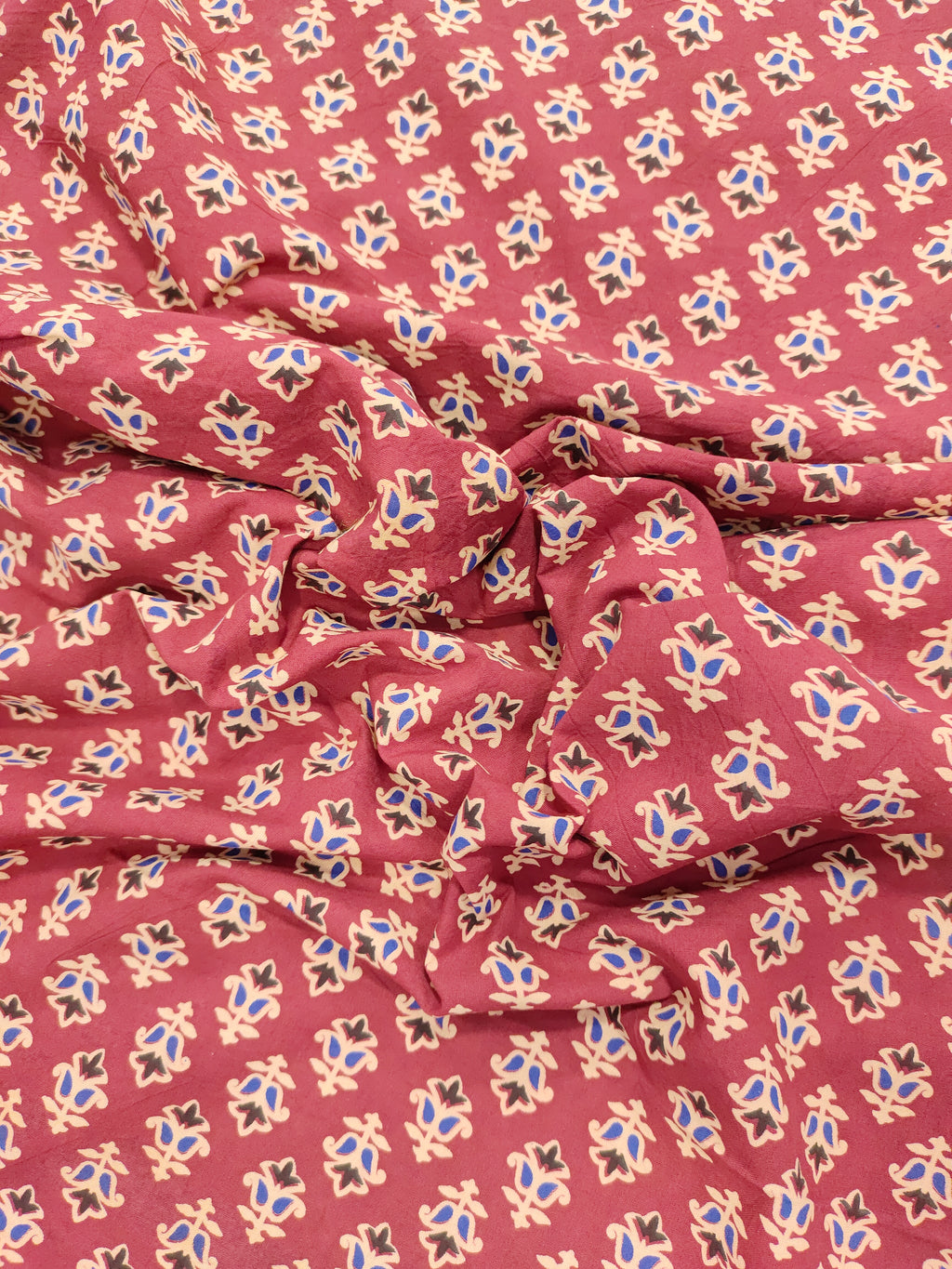 Maroon base cotton small ajrak butti fabric.