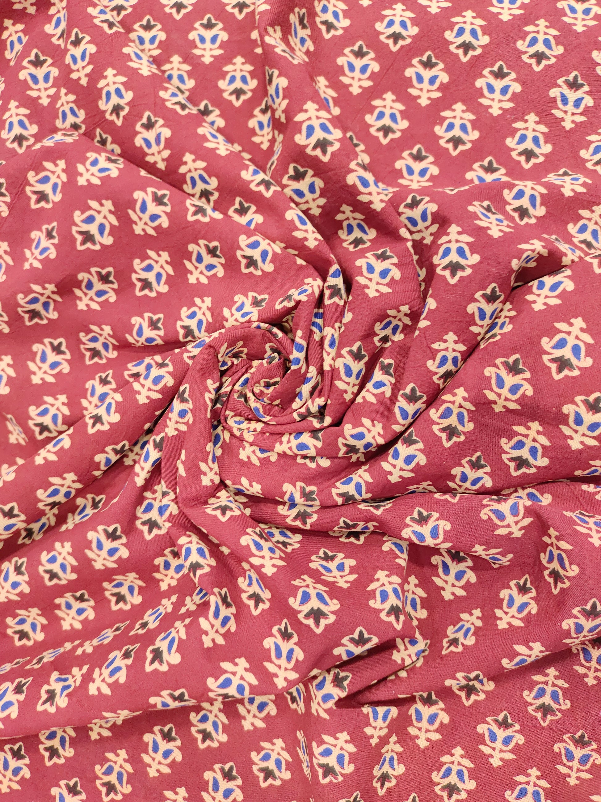 Maroon base cotton small ajrak butti fabric.
