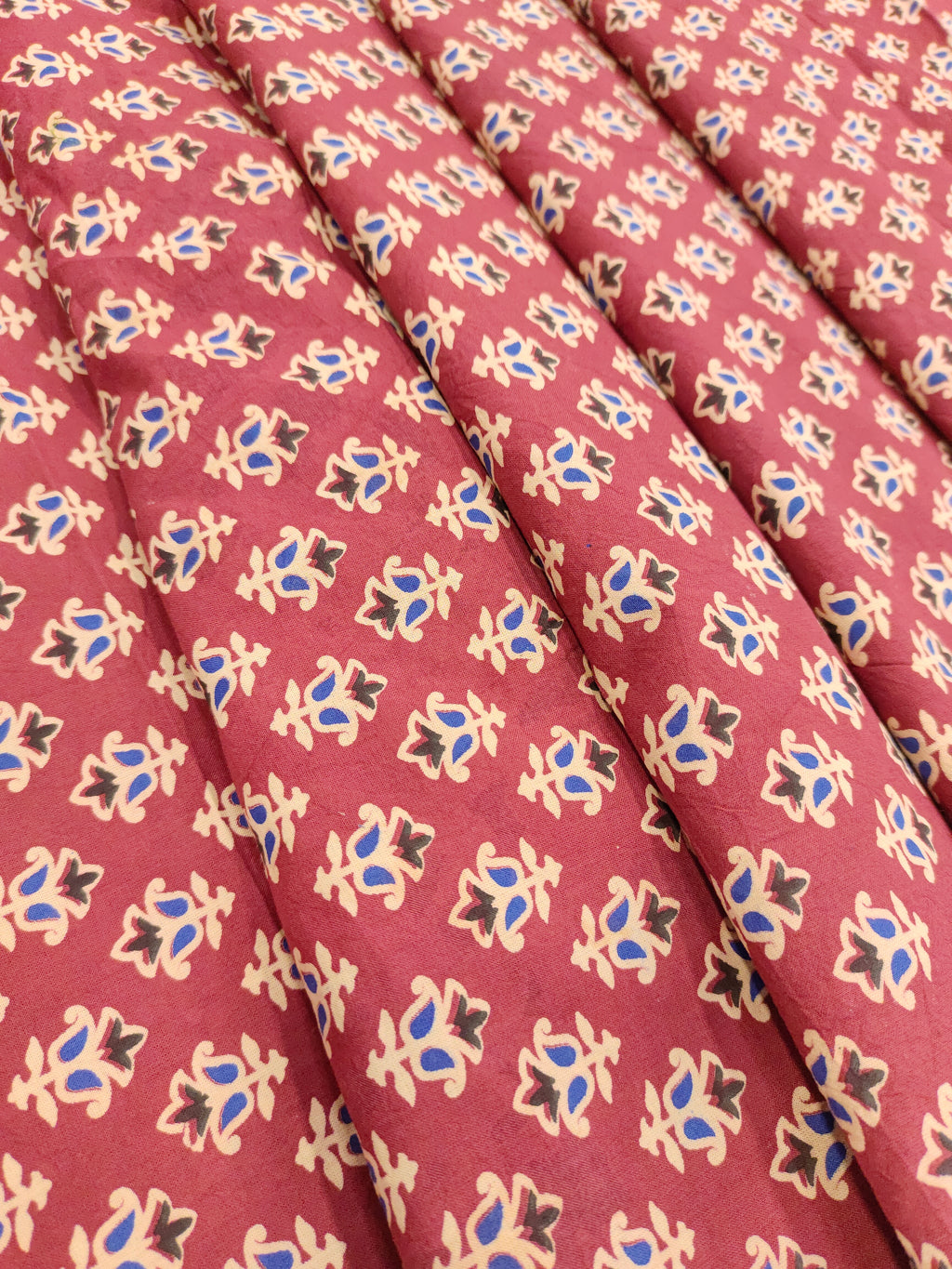 Maroon base cotton small ajrak butti fabric.
