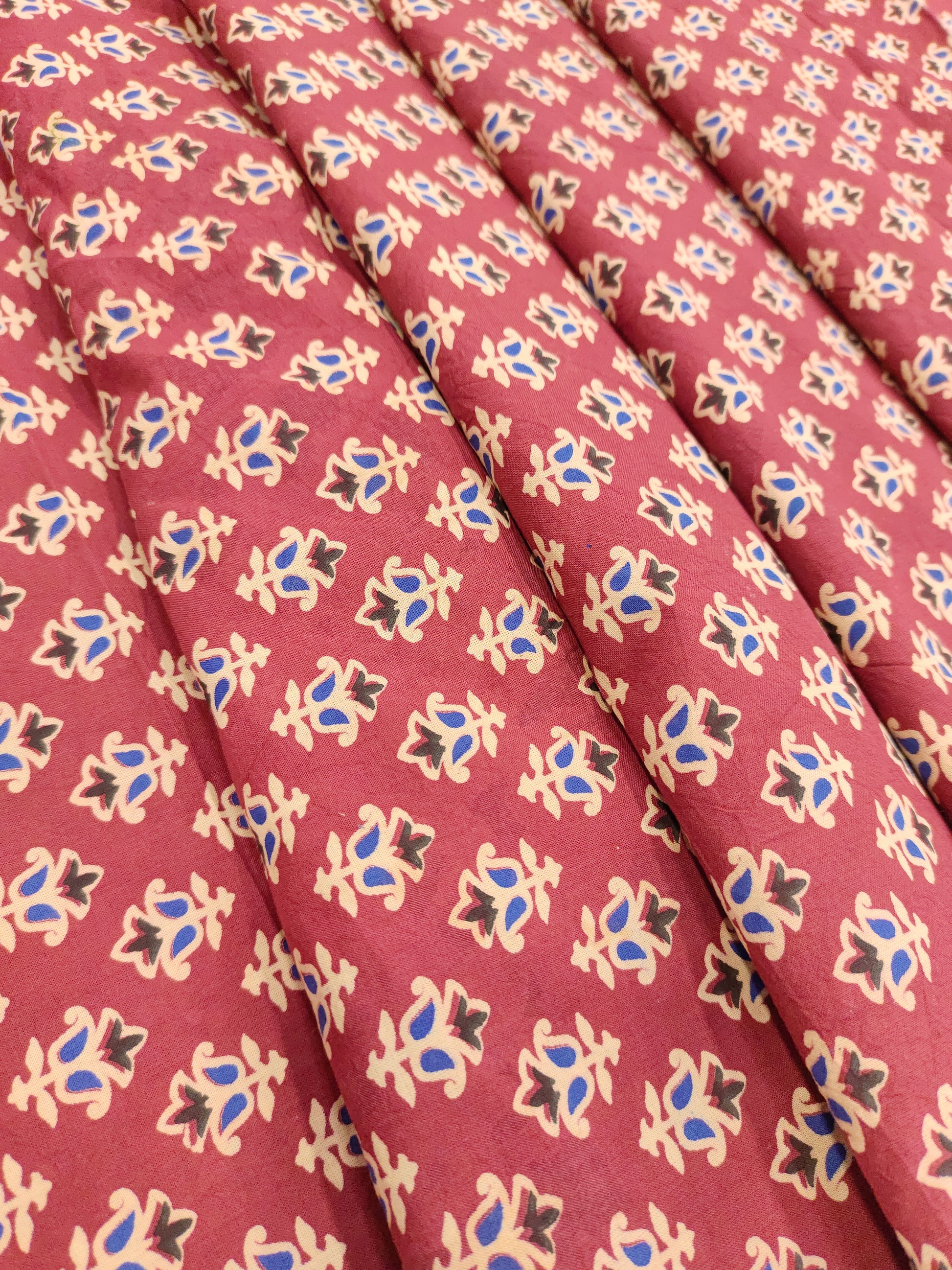 Maroon base cotton small ajrak butti fabric.