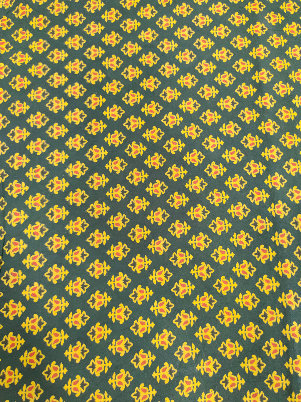 Green and yellow pure cotton ajrak print in small butti.