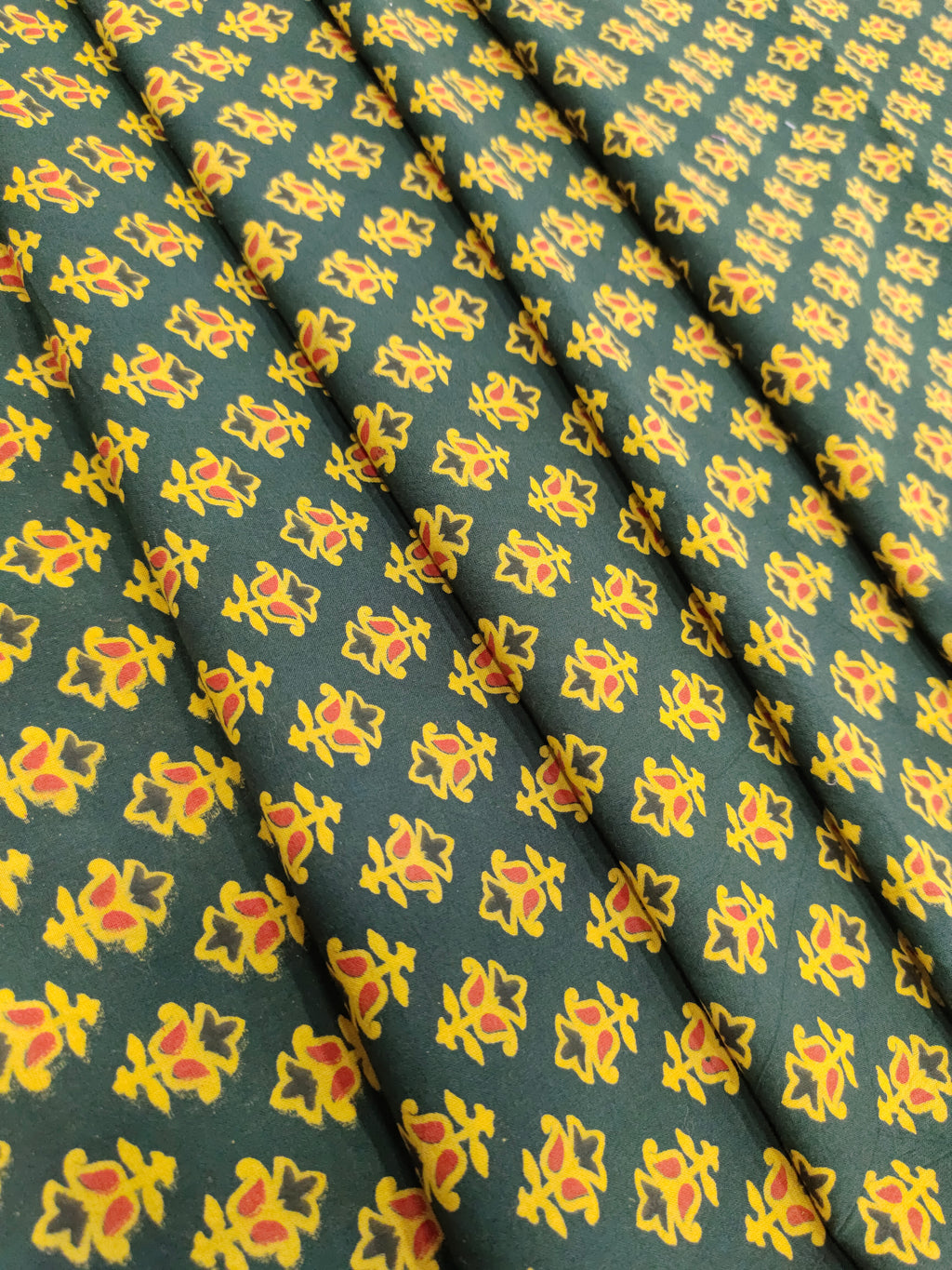 Green and yellow pure cotton ajrak print in small butti.