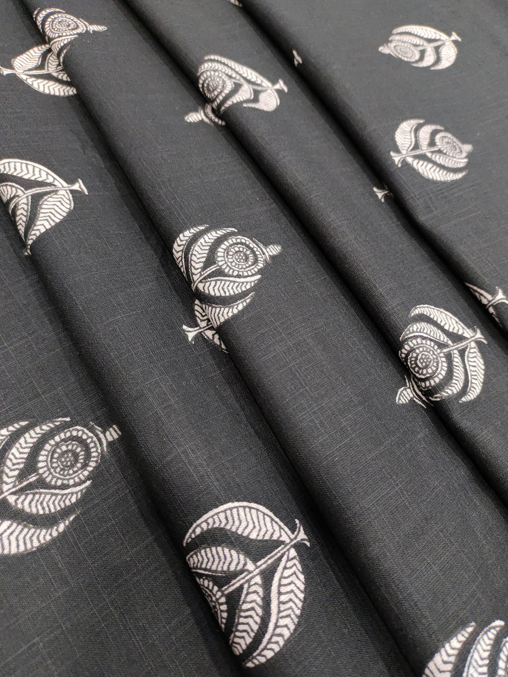 Black cotton slub fabric with offwhite moghal print