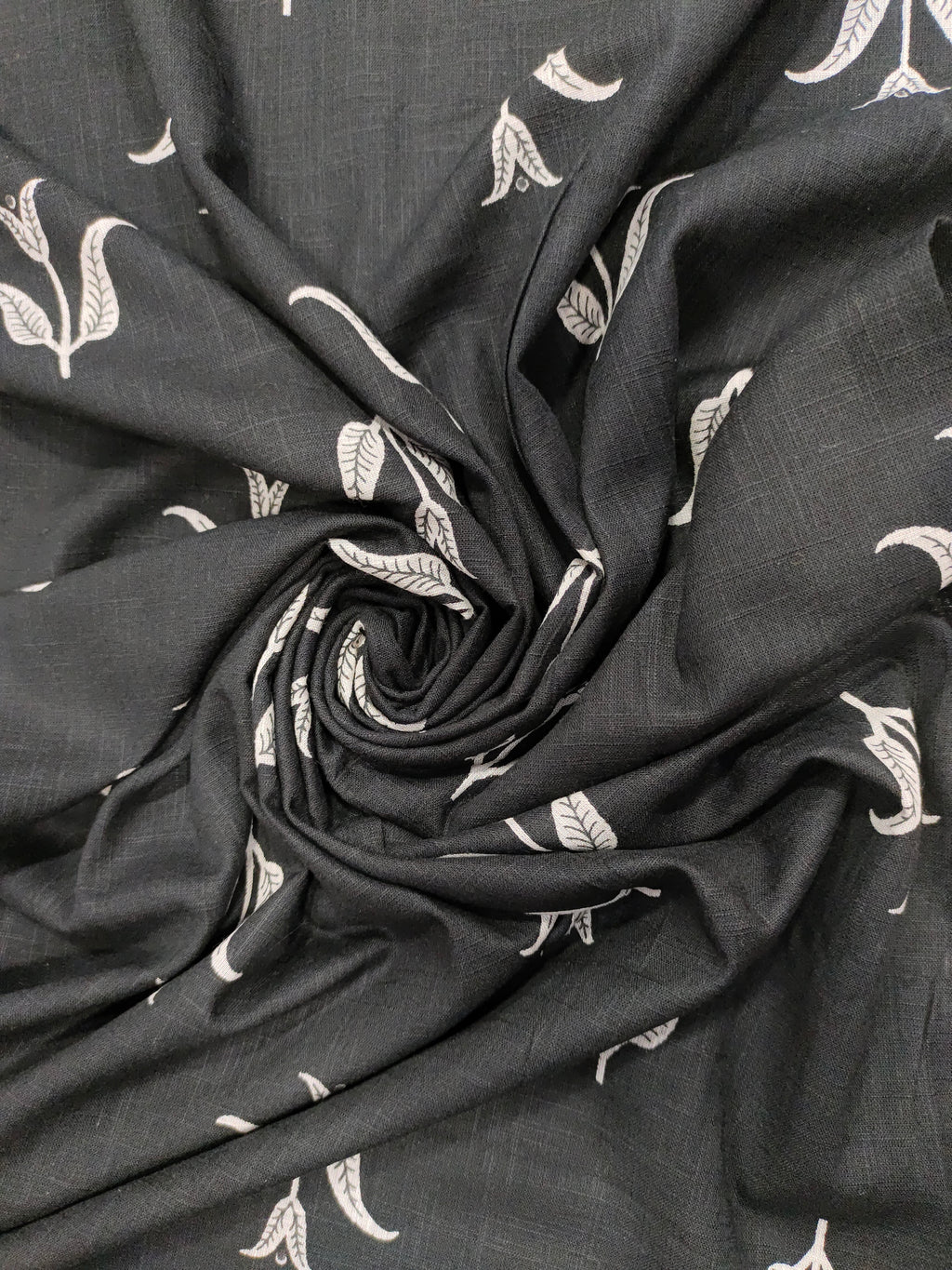 Black cotton slub fabric with leaves print.