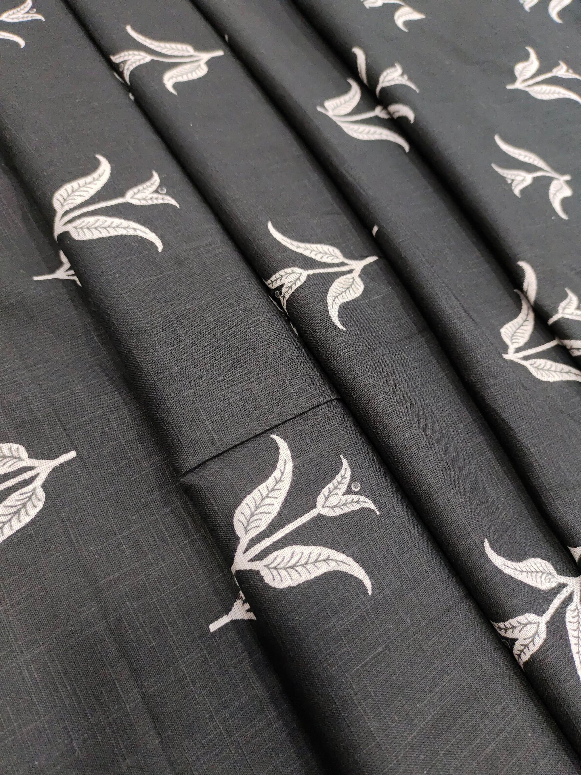 Black cotton slub fabric with leaves print.