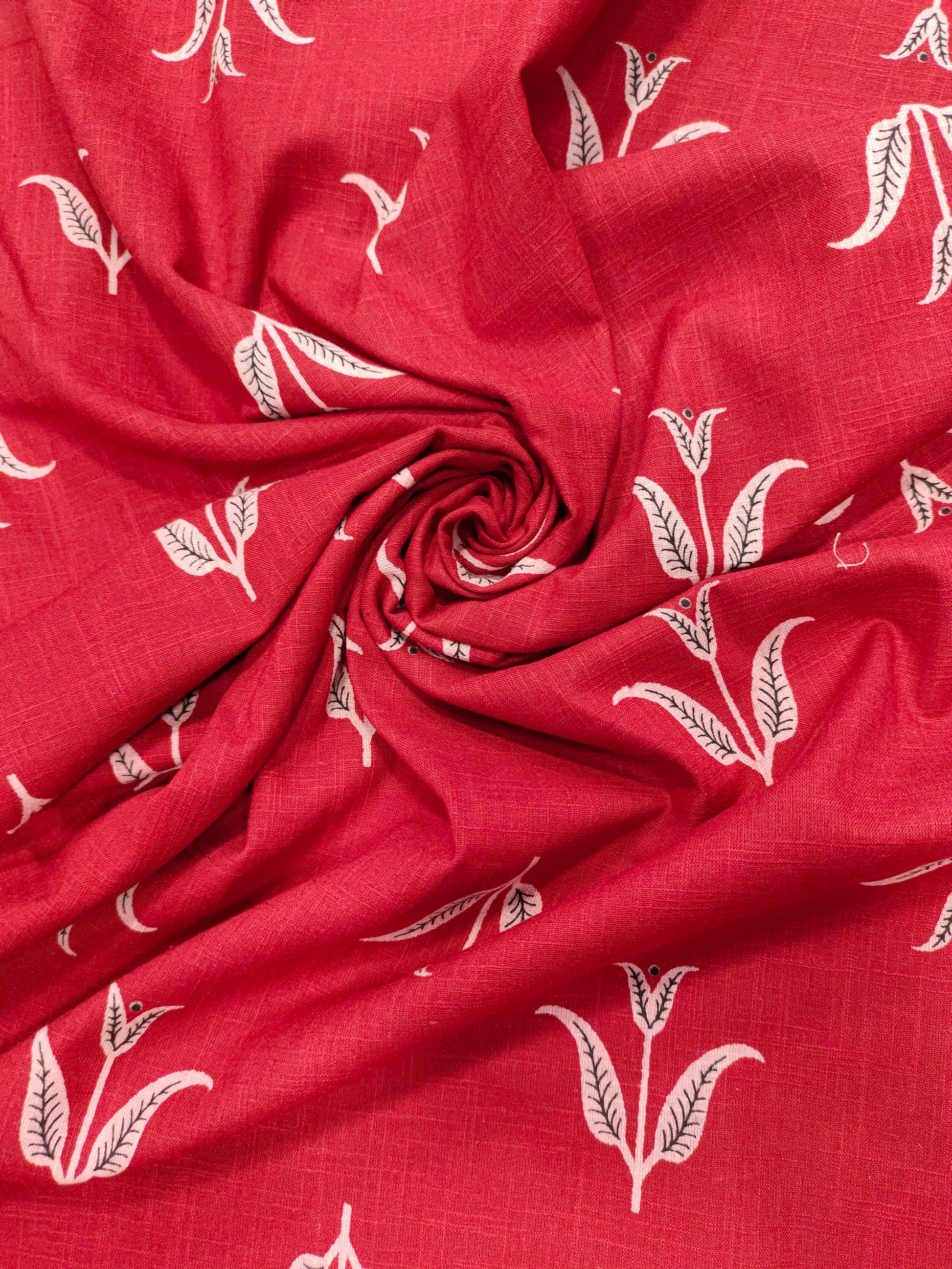 Red cotton slub fabric with black butti print.