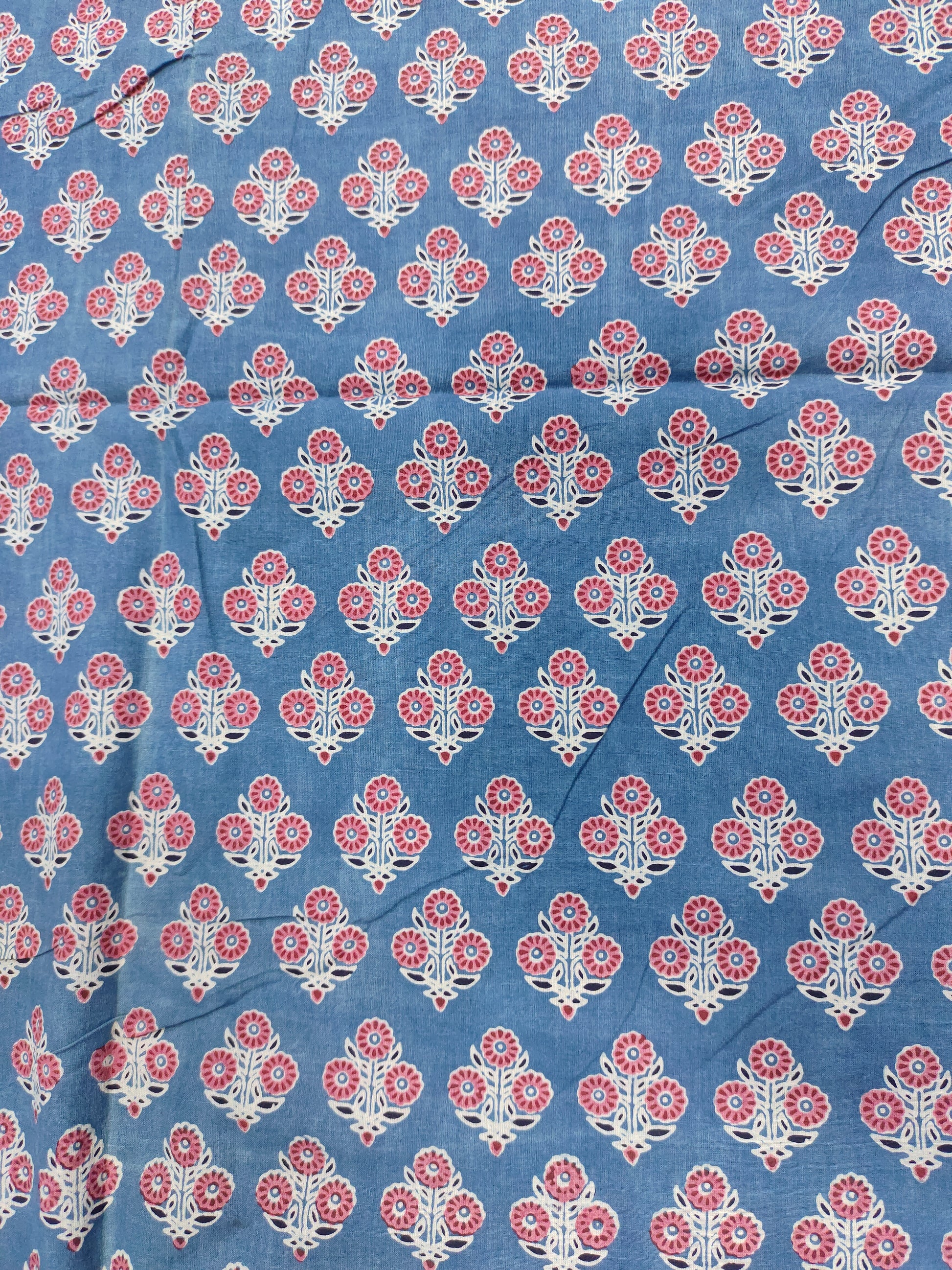 Blue ajrak print with red and white motifs.