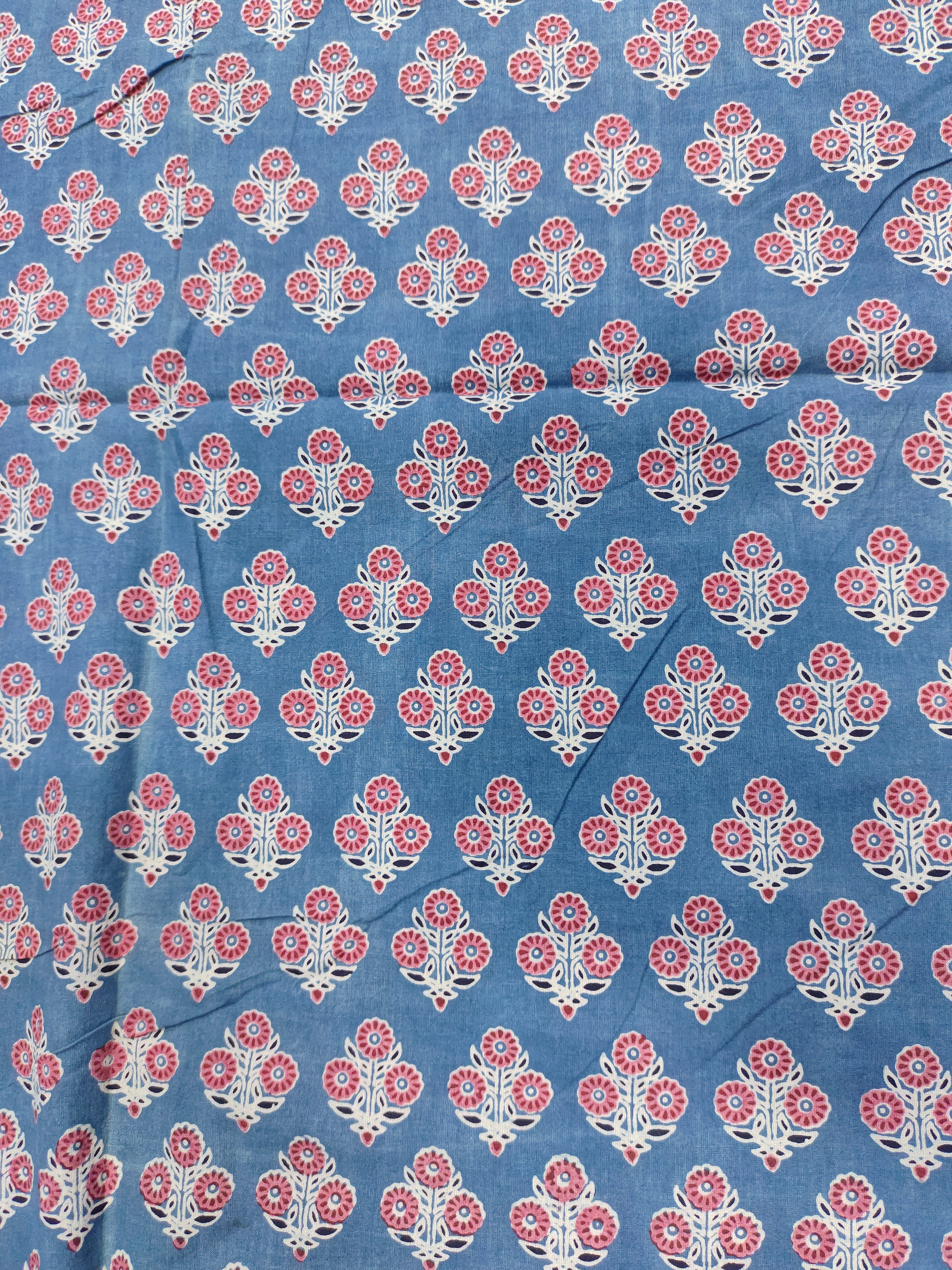 Blue ajrak print with red and white motifs.