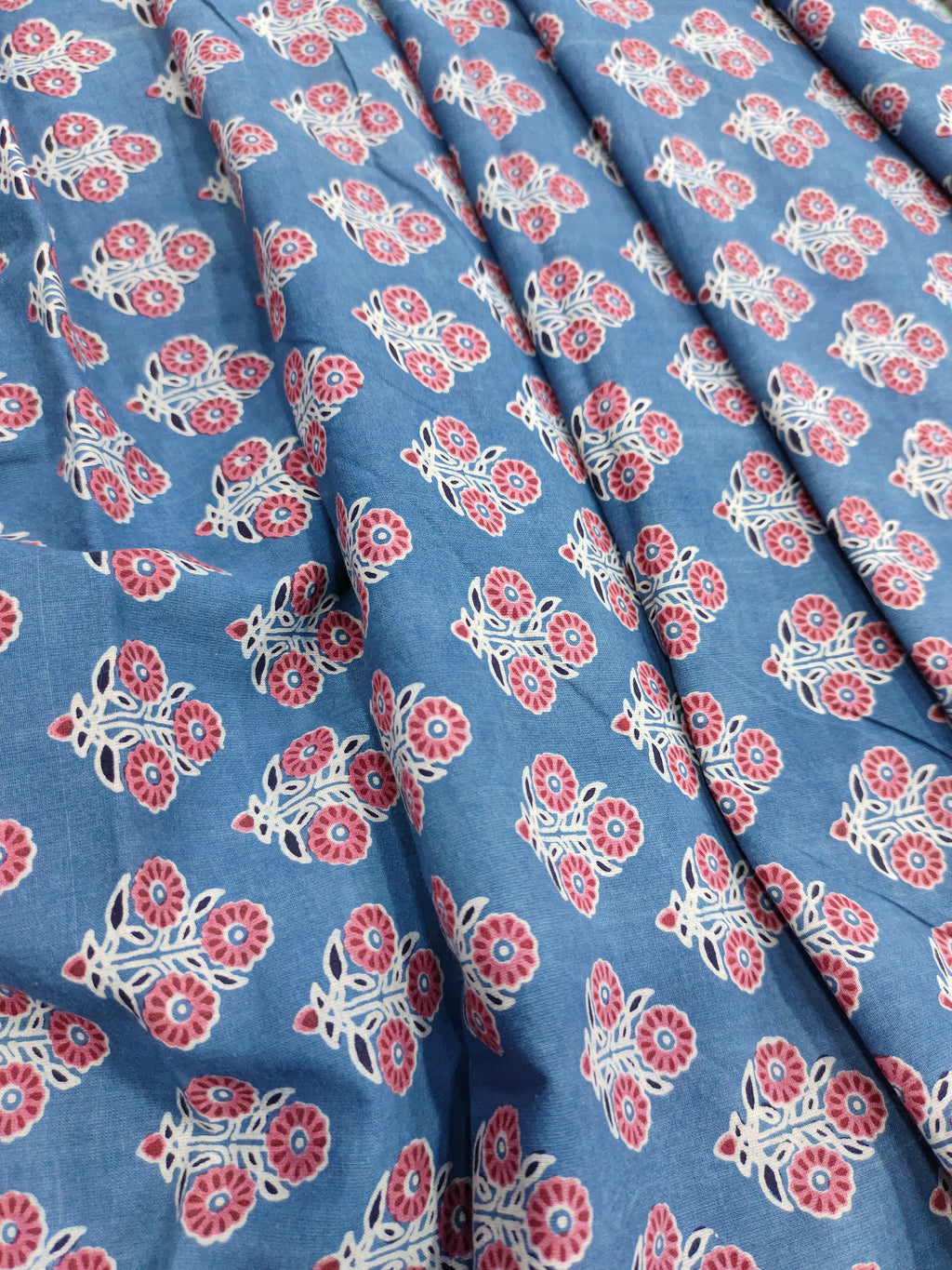 Blue ajrak print with red and white motifs.