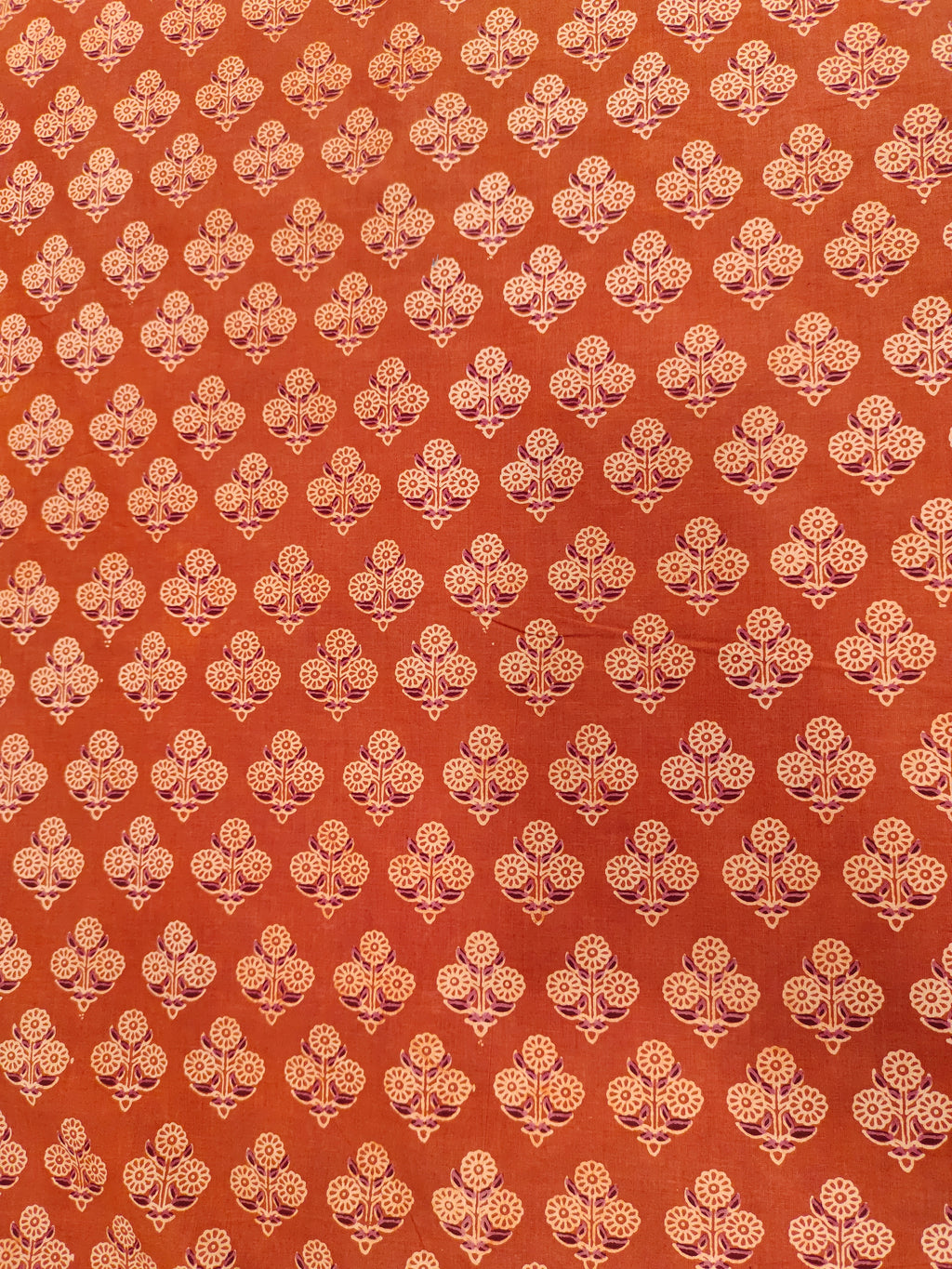 Orangish rust ajrak print with beige and maroon.