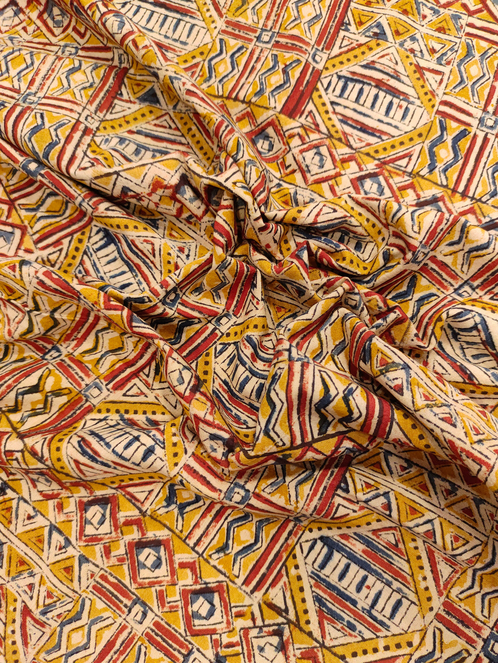 Dark mustard kalamkari printed with red and blue.