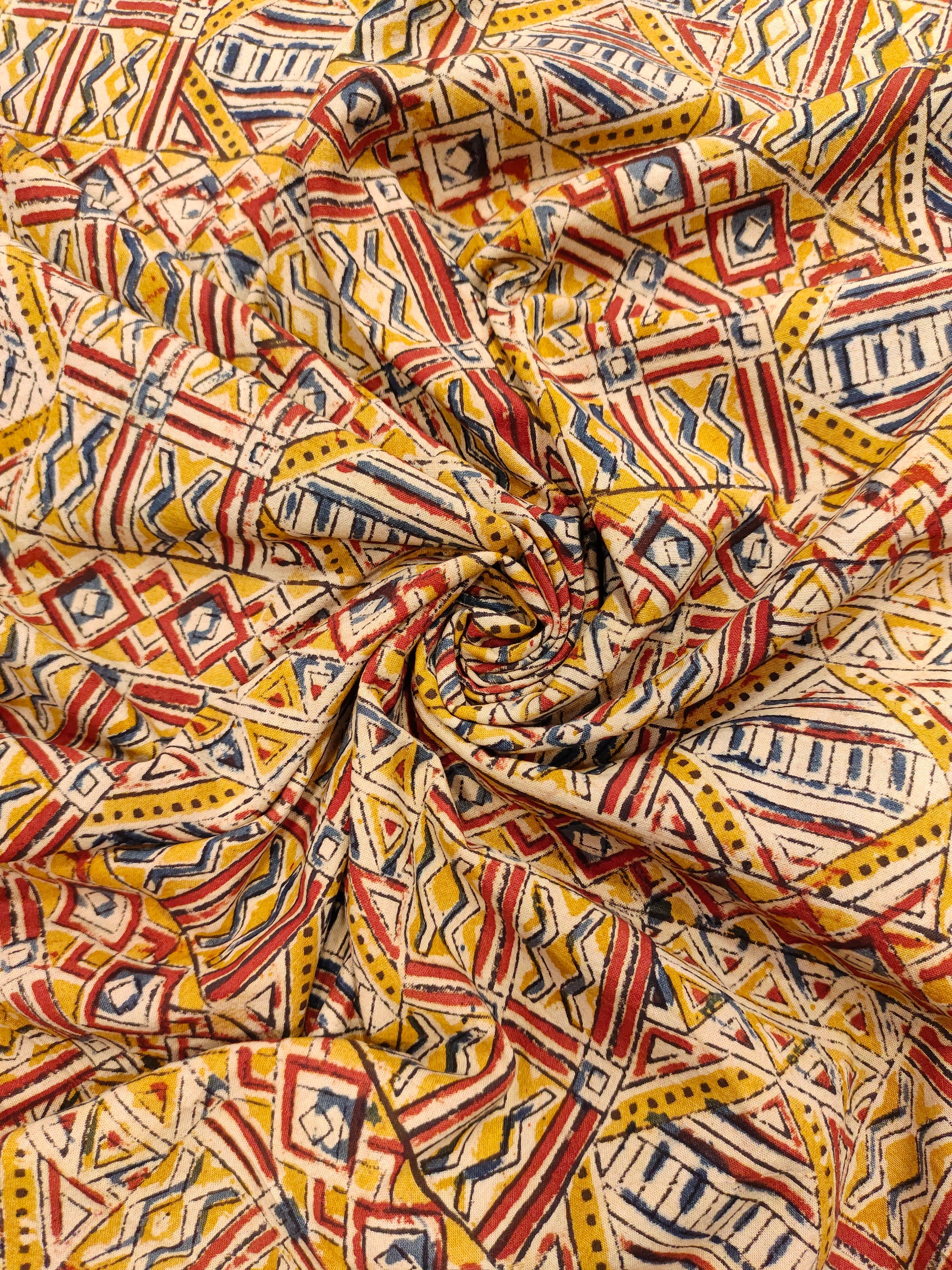 Dark mustard kalamkari printed with red and blue.