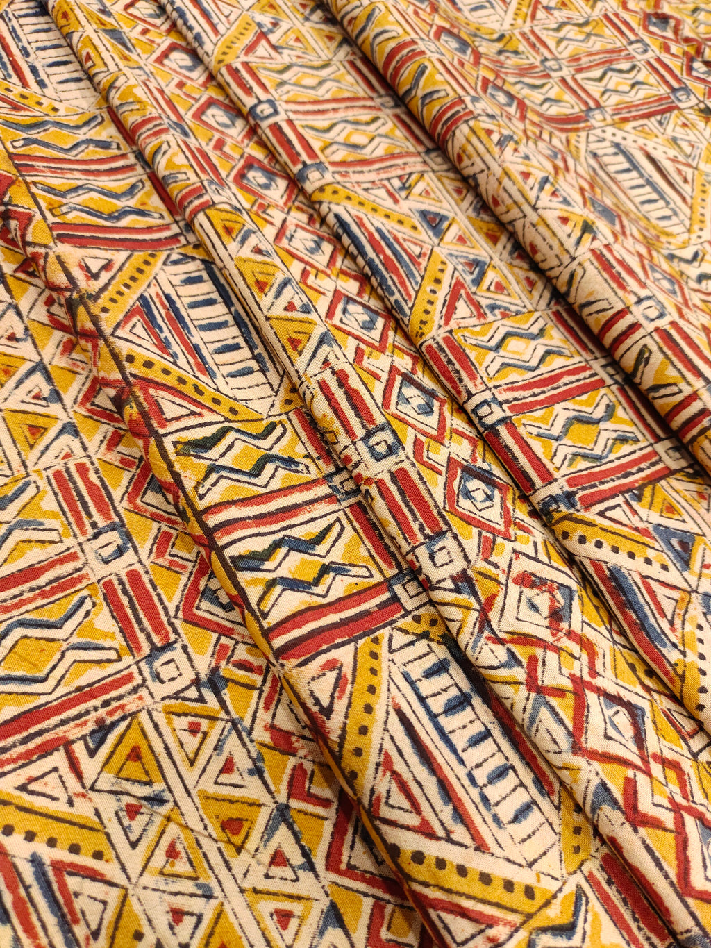 Dark mustard kalamkari printed with red and blue.