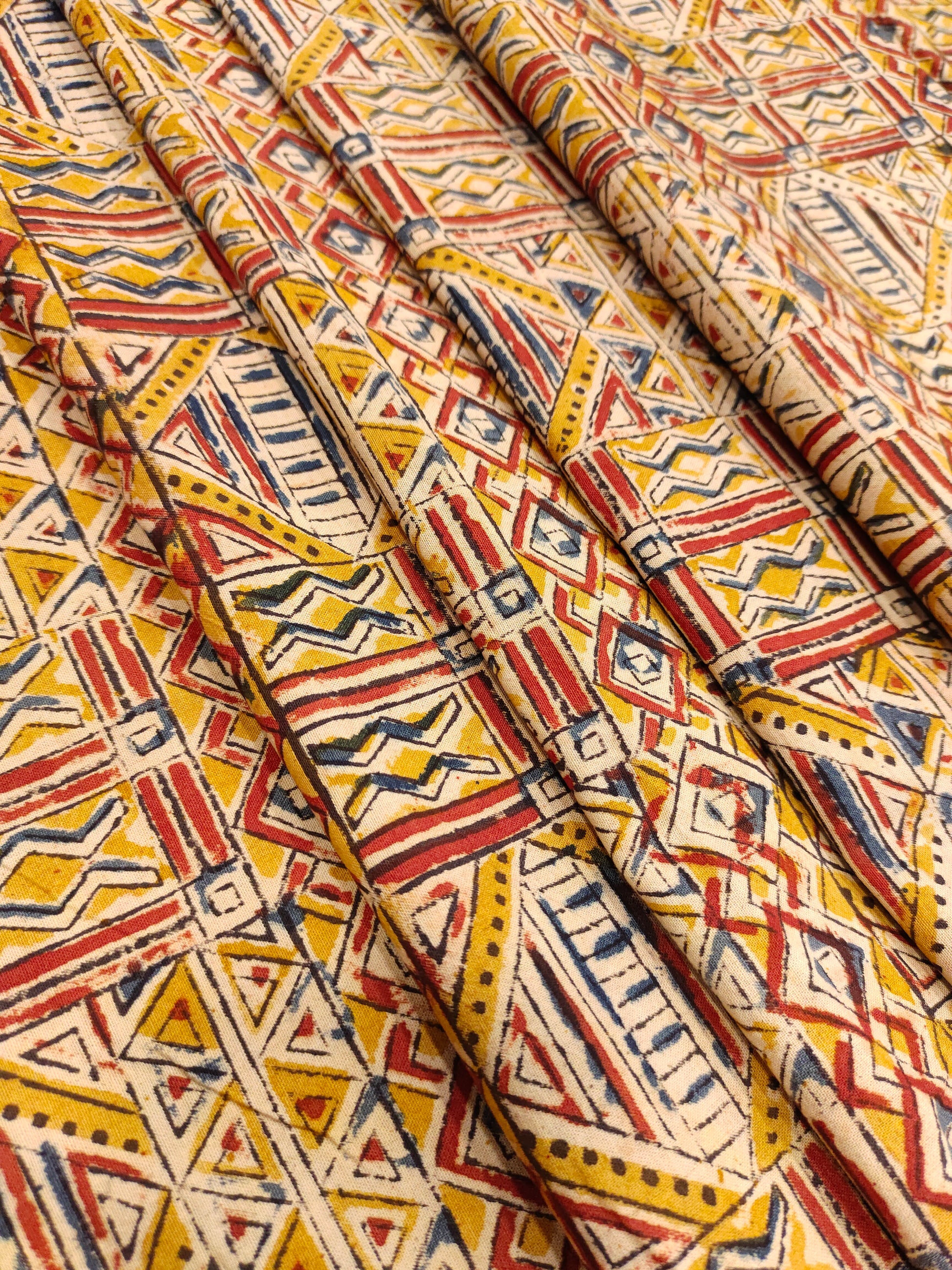 Dark mustard kalamkari printed with red and blue.