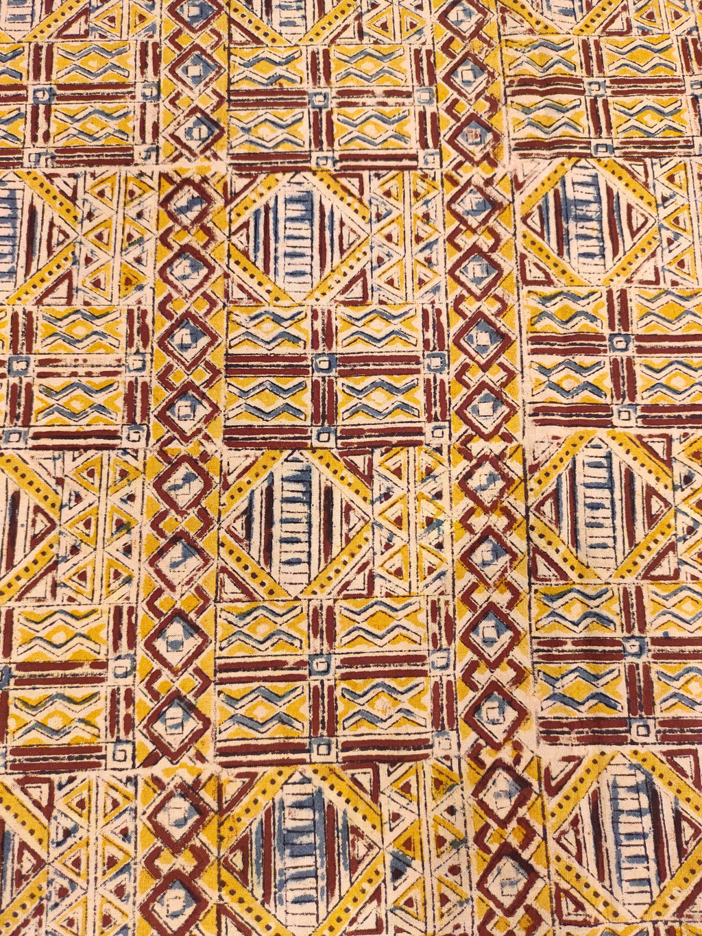 Mango yellow kalamkari with orange maroon and blue.