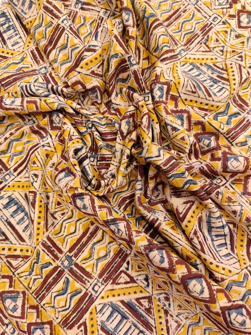 Mango yellow kalamkari with orange maroon and blue.