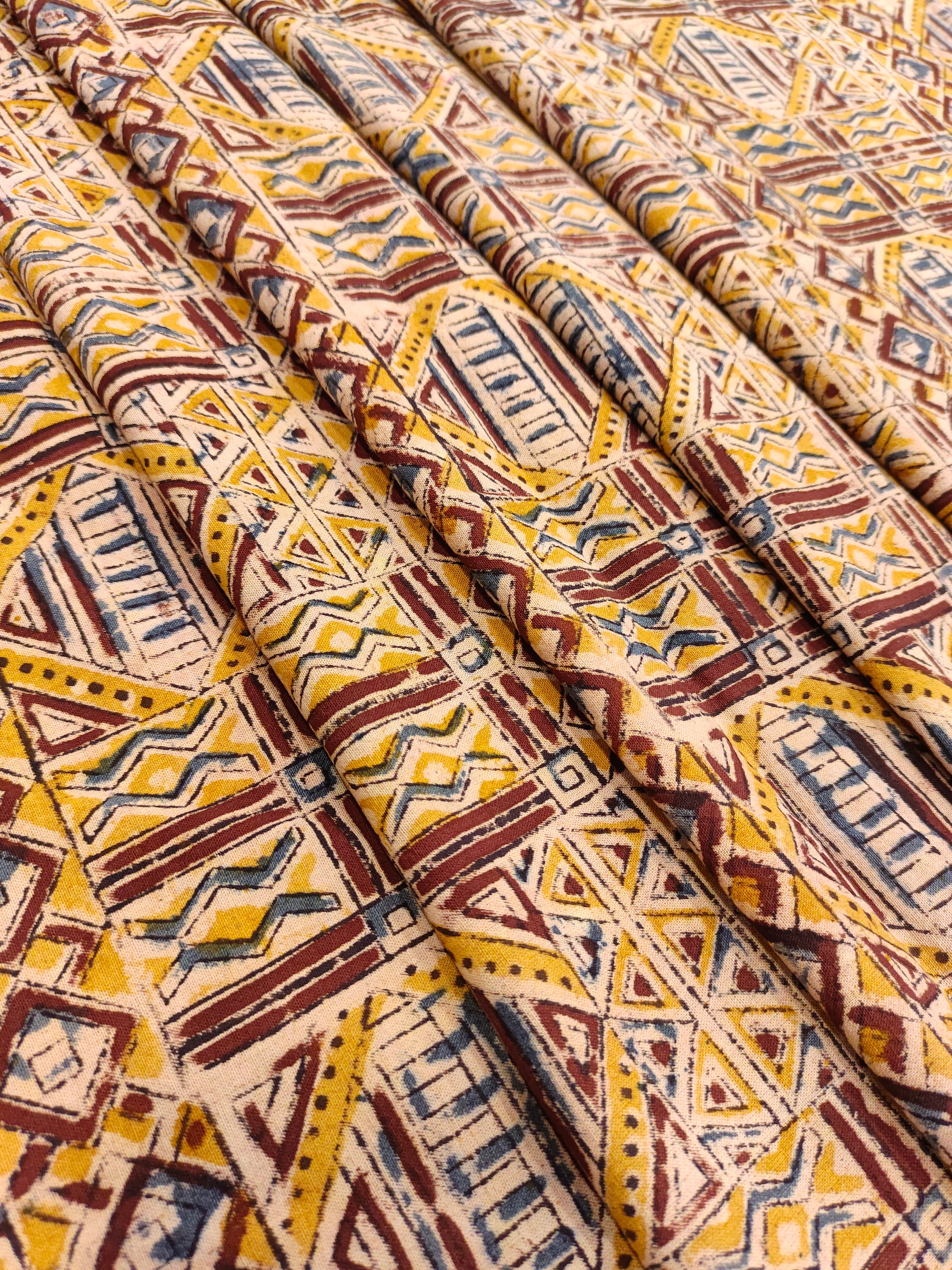 Mango yellow kalamkari with orange maroon and blue.