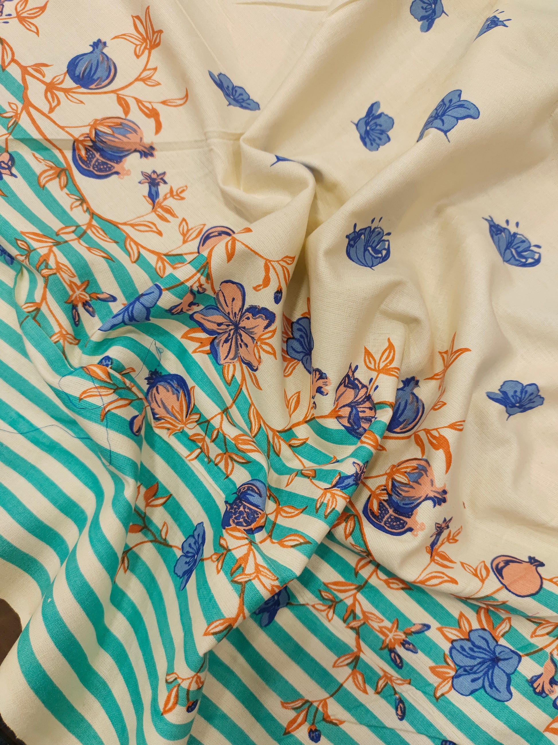 Cream flex cotton daman print green blue and orange.