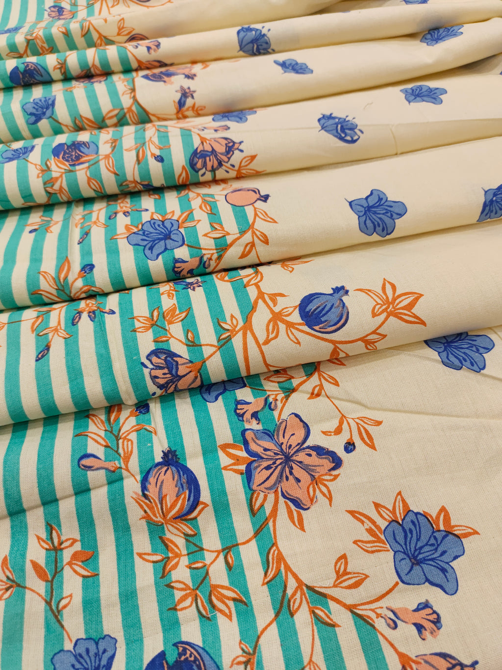 Cream flex cotton daman print green blue and orange.