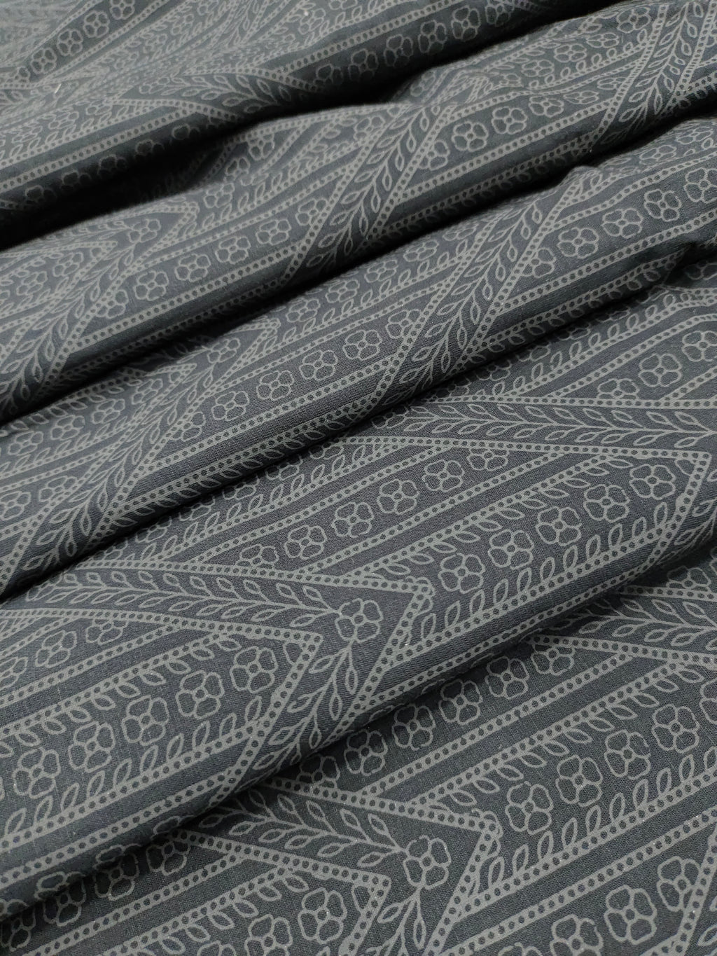 Black cotton fabric with grey stripes print.