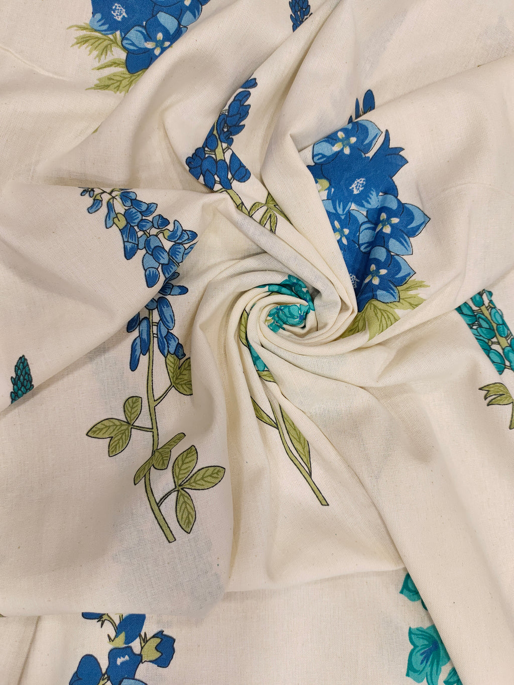 Cream cotton flex fabric stem type print with blue and green.