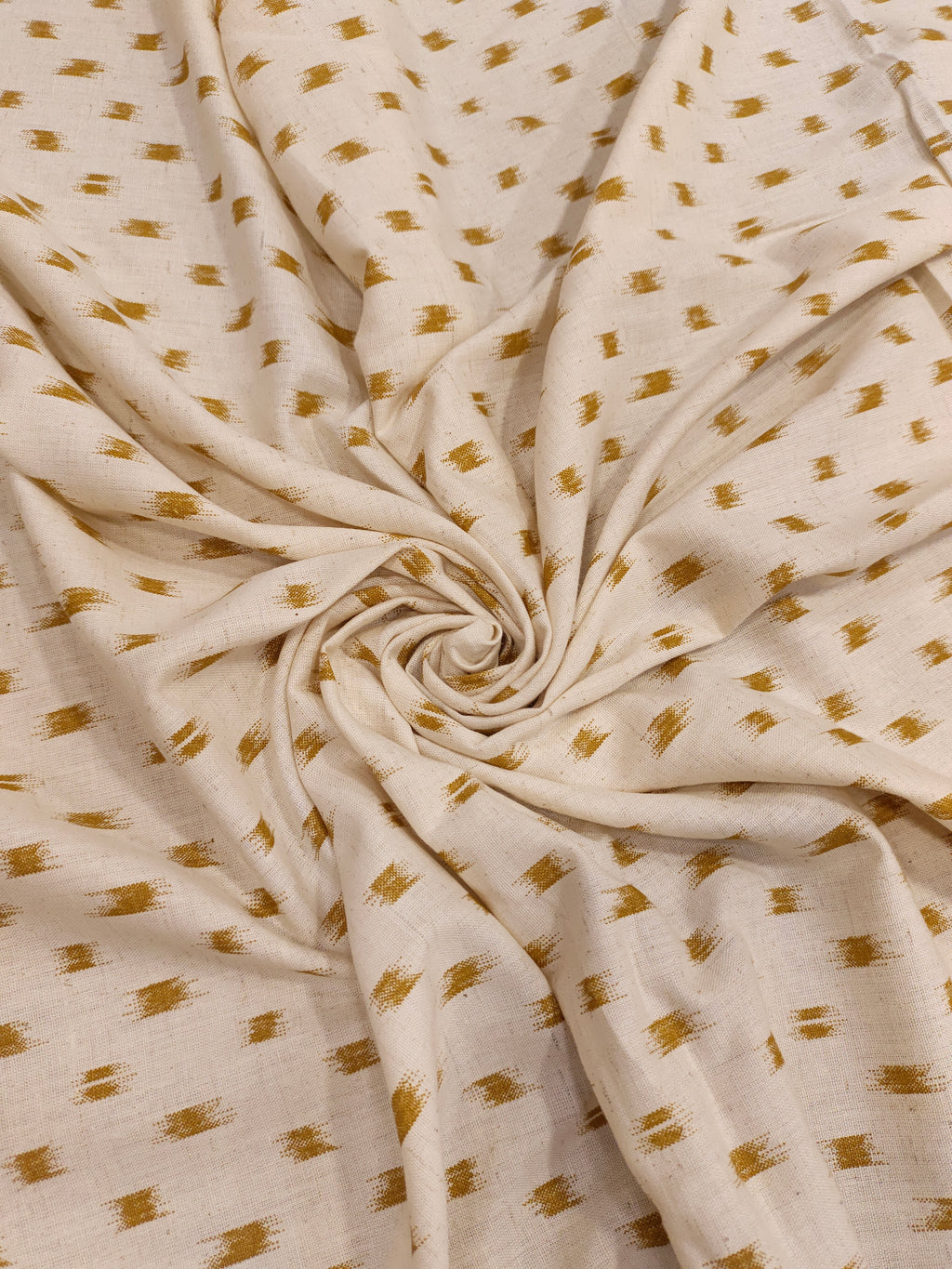 Cream cotton flex fabric mustard ikkat print.