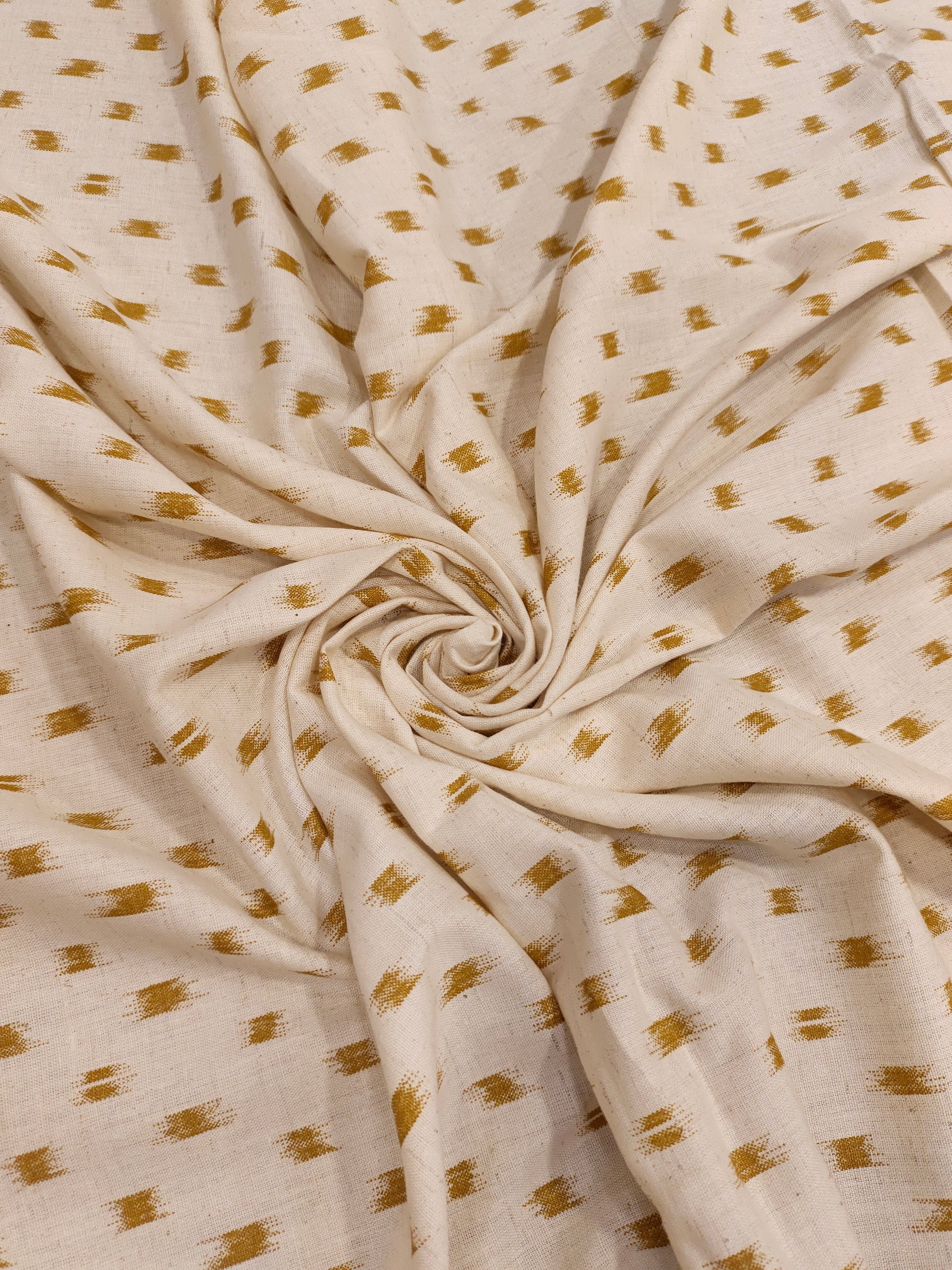 Cream cotton flex fabric mustard ikkat print.