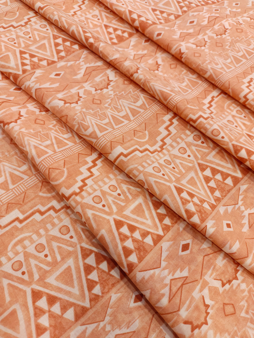 Cream fabric with broad peach stripes print.