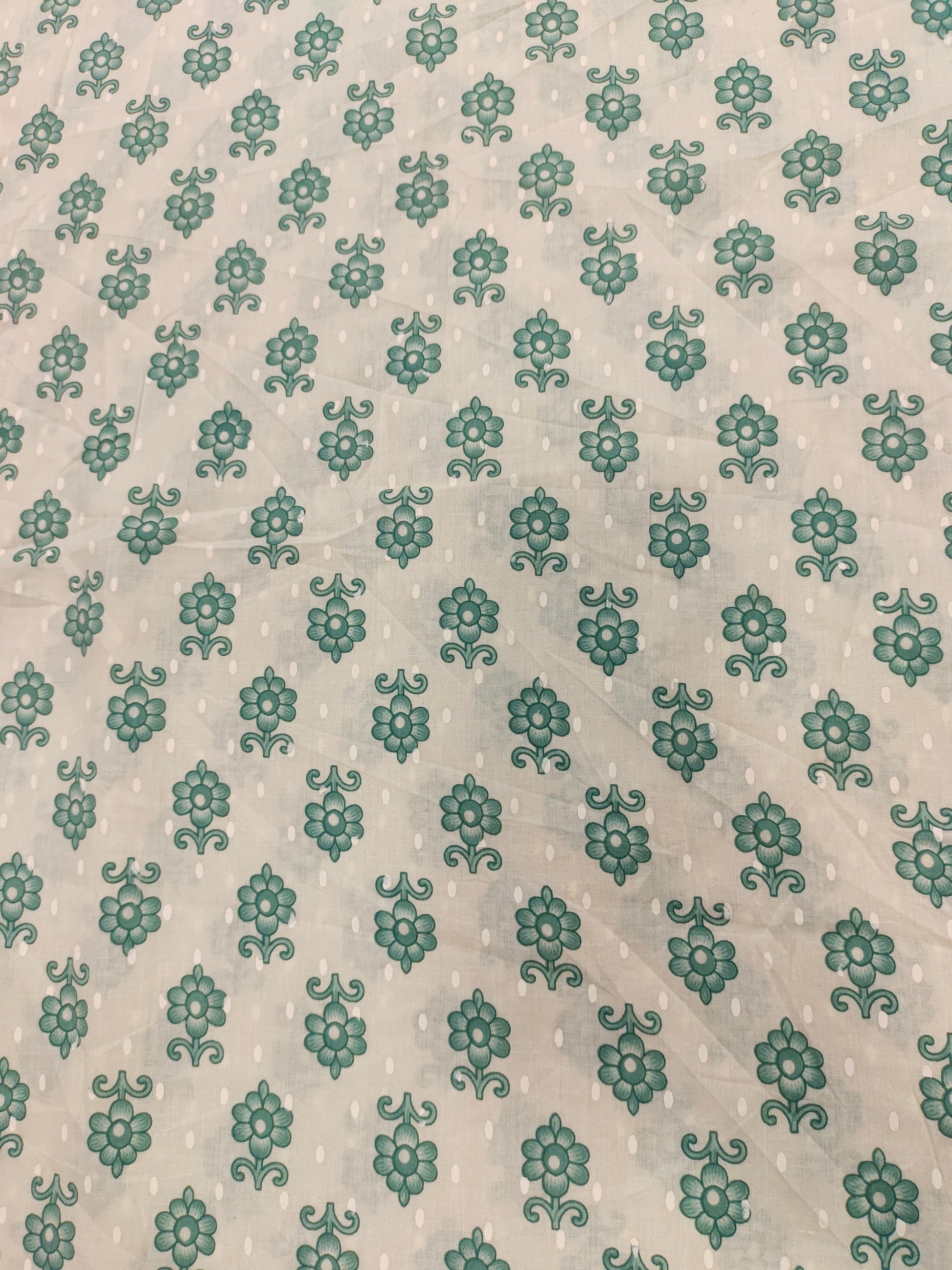 Cream cotton base floral print with green.